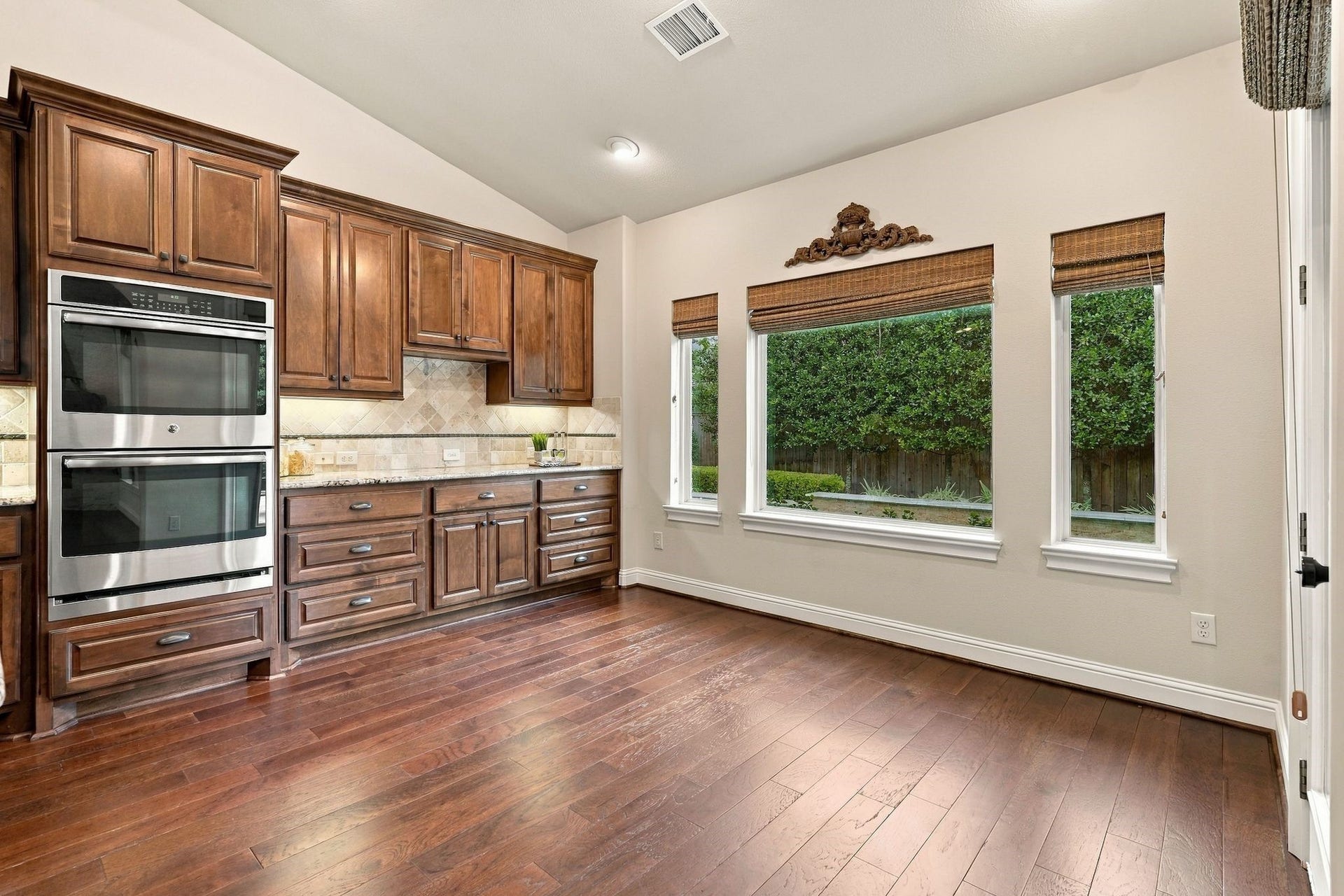 51 Woodglade Way, The Woodlands, TX 77375 Spacious breakfast area overlooking the backyard pool and lush landscaping.