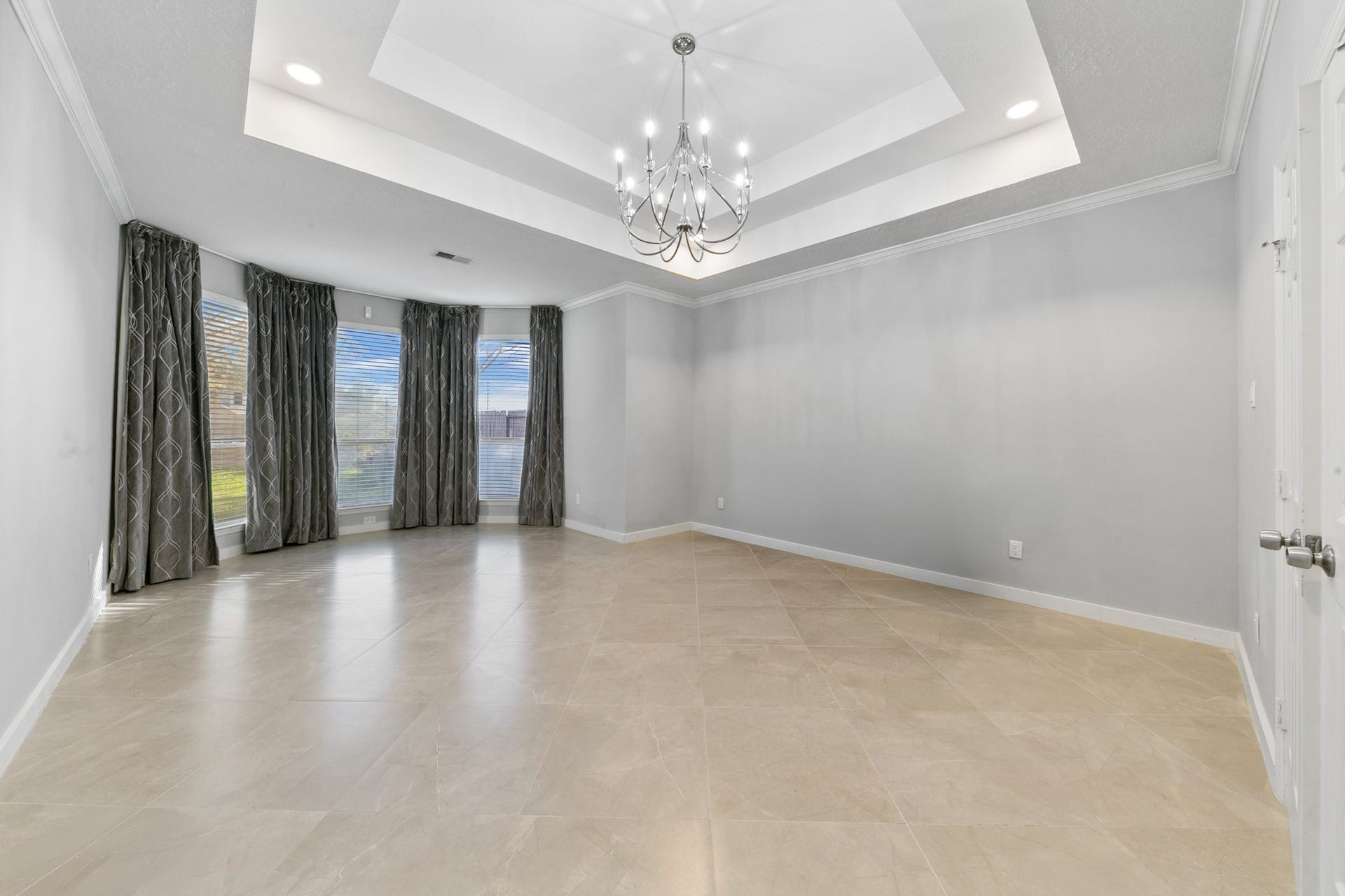 1931 Timber Creek Drive, Missouri City, TX 77459 Large Master bedroom with beautiful tray ceiling and chandelier. .