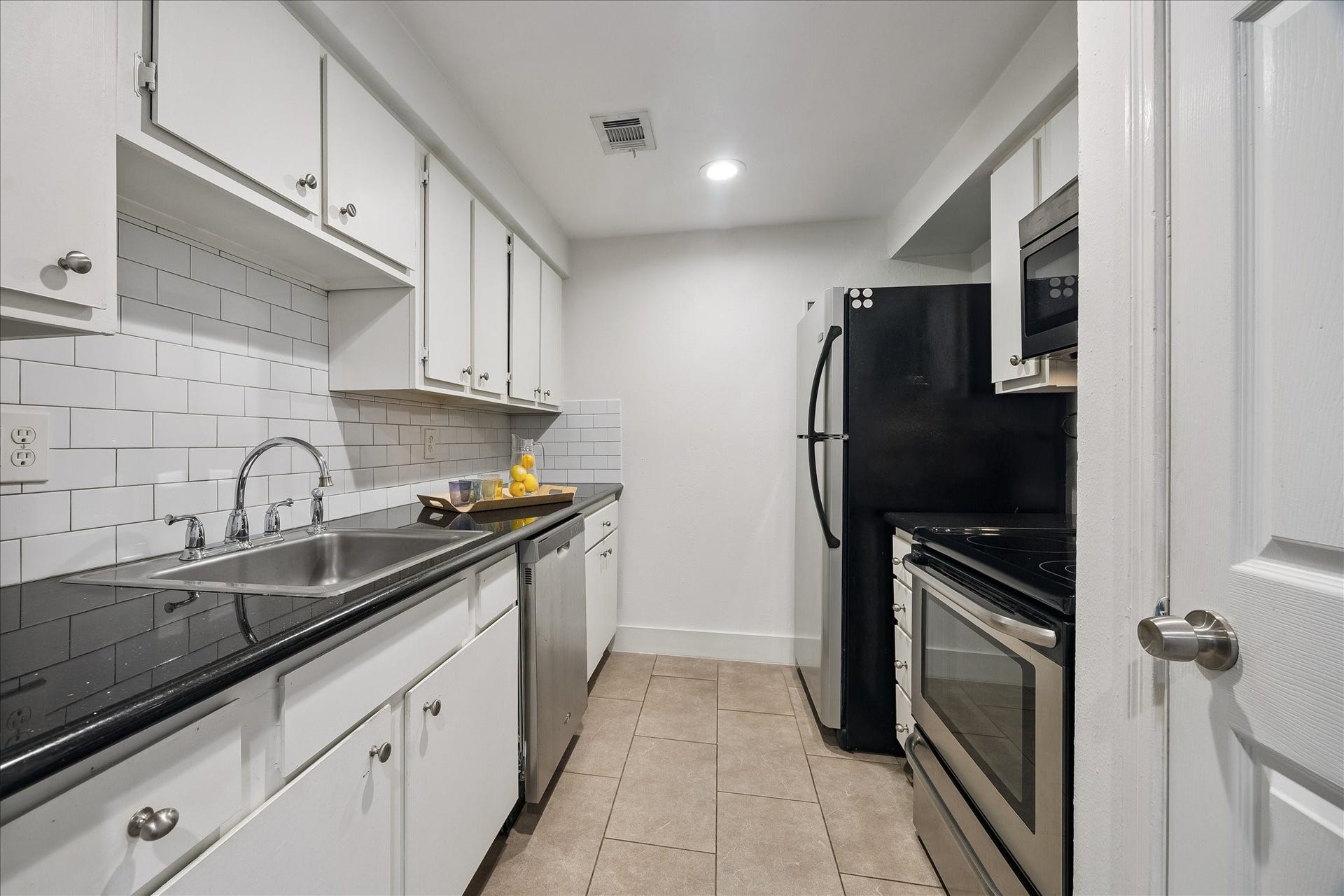 Kitchen with Granite Countertops and Stainless Appliances.  Extra Space with Reach-In Pantry