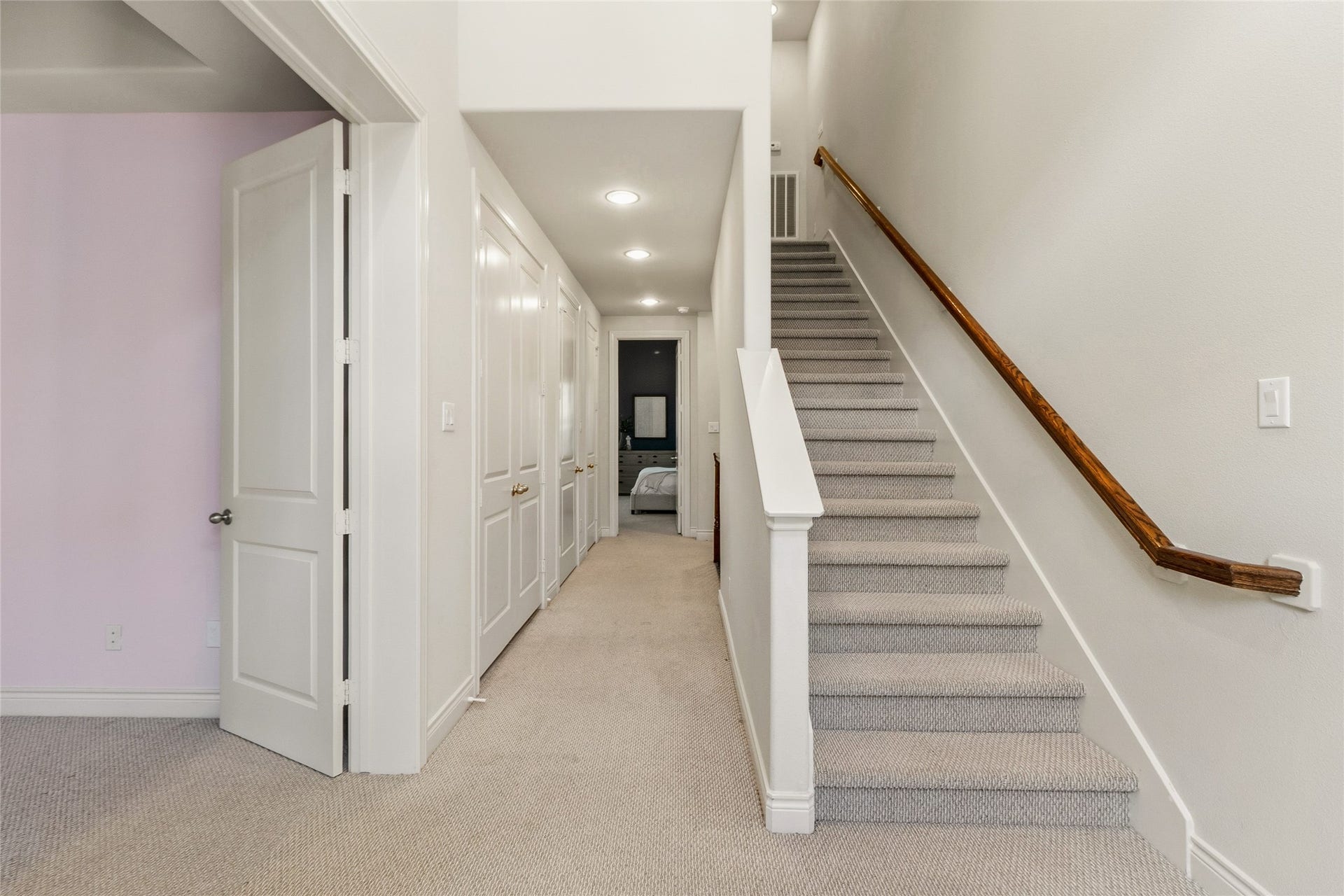 2823 Sherwin Street, Houston, TX 77007 Bright second-floor landing with recessed lighting, plush carpet, and a staircase leading up to the third level.