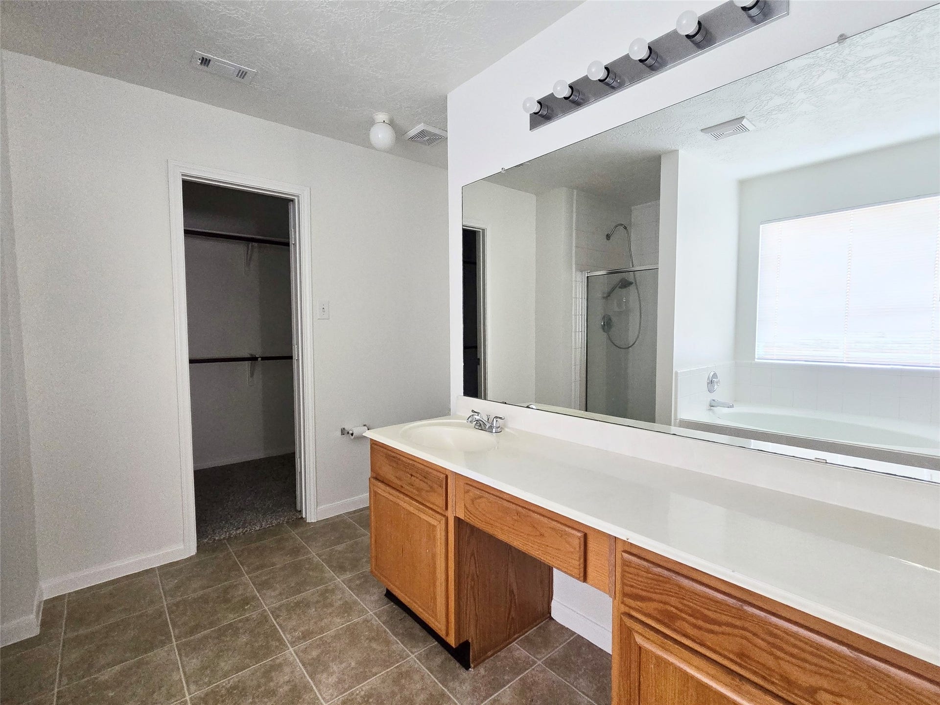 32223 Decker Oaks Drive, Pinehurst, TX 77362 A knee space and plenty of countertop space at the vanity creates a dedicated space for getting ready every day.