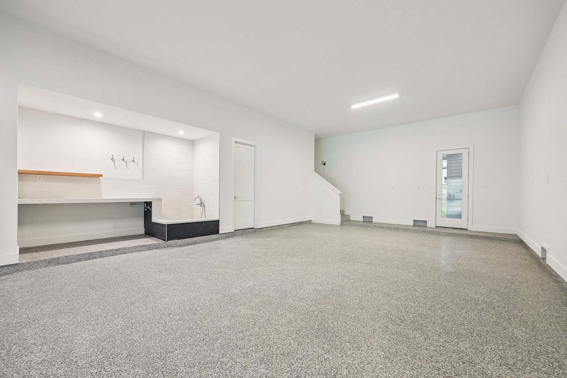 Incredible Four Car Garage with an Epoxy Treated Floor, plus extra storage and access to the elevator shaft. The Garage is also Pre-Wired for Two 220V Outlets.