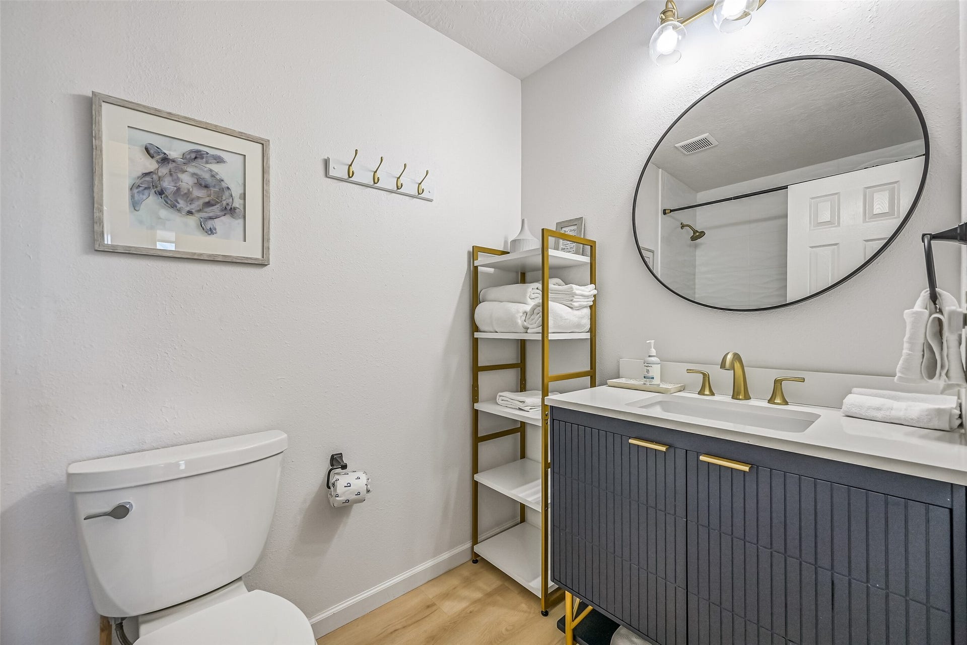 17620 Glei, Galveston, TX 77554 The renovated guest bathroom hosts a tub/shower combo with gold accents throughout.
