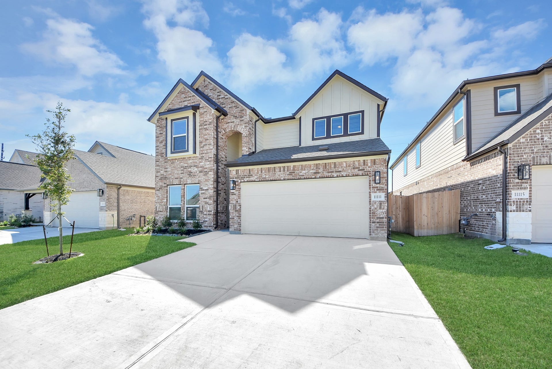 The residence features a practical 2-car garage complemented by a generous driveway, ensuring abundant space for parking needs.