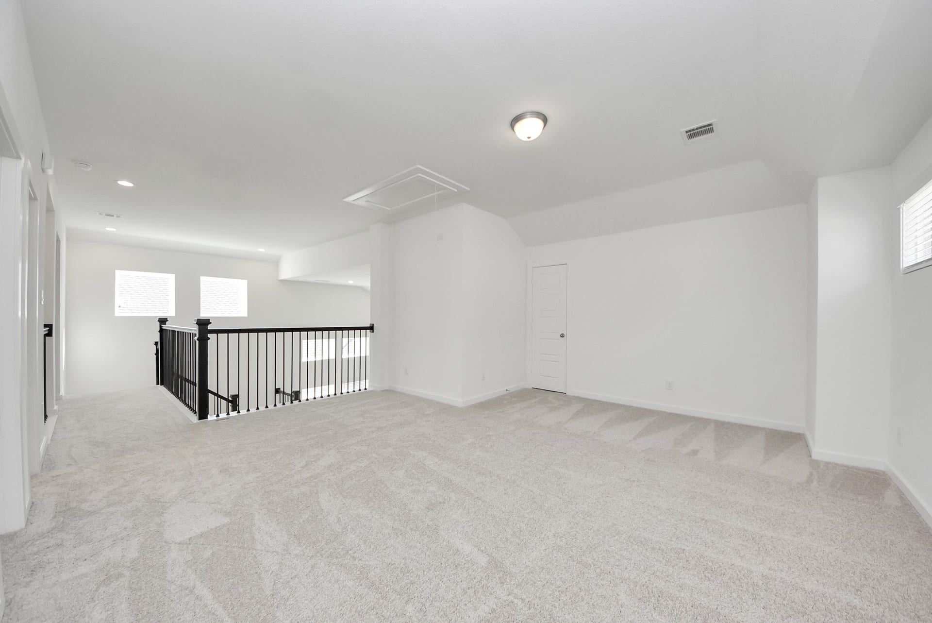 Ascend to relaxation in this fantastic game room! Ideal for both casual gatherings and adult gaming, it boasts plush carpet, lofty ceilings, custom paint, and ample windows for abundant natural light