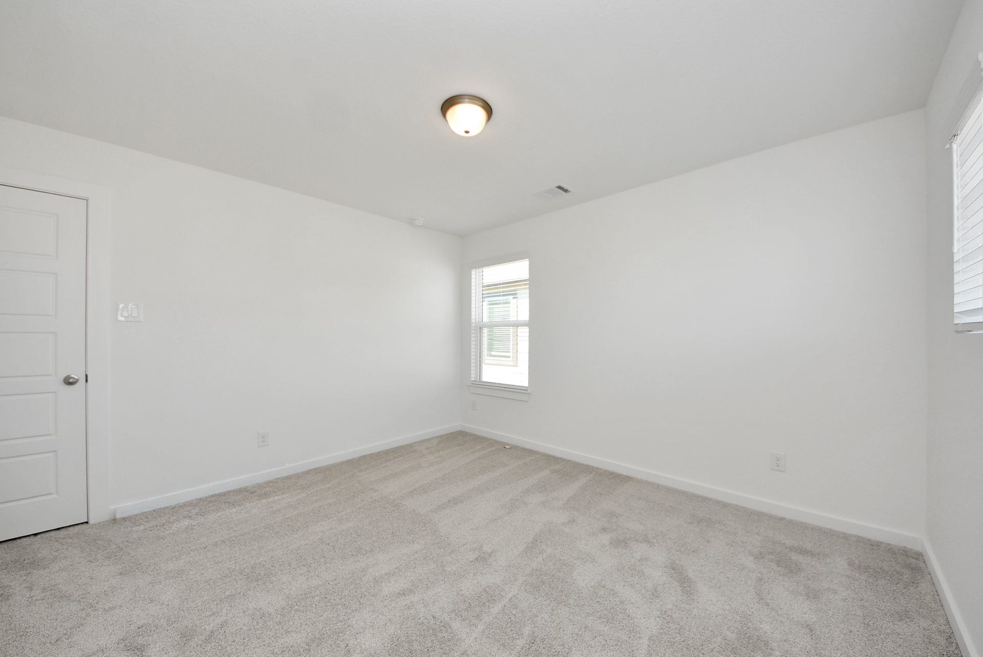 Generously sized secondary bedrooms featuring spacious closets, soft and inviting carpeting underfoot, large windows allowing plenty of natural light, and the added touch of privacy blinds for your personal retreat.