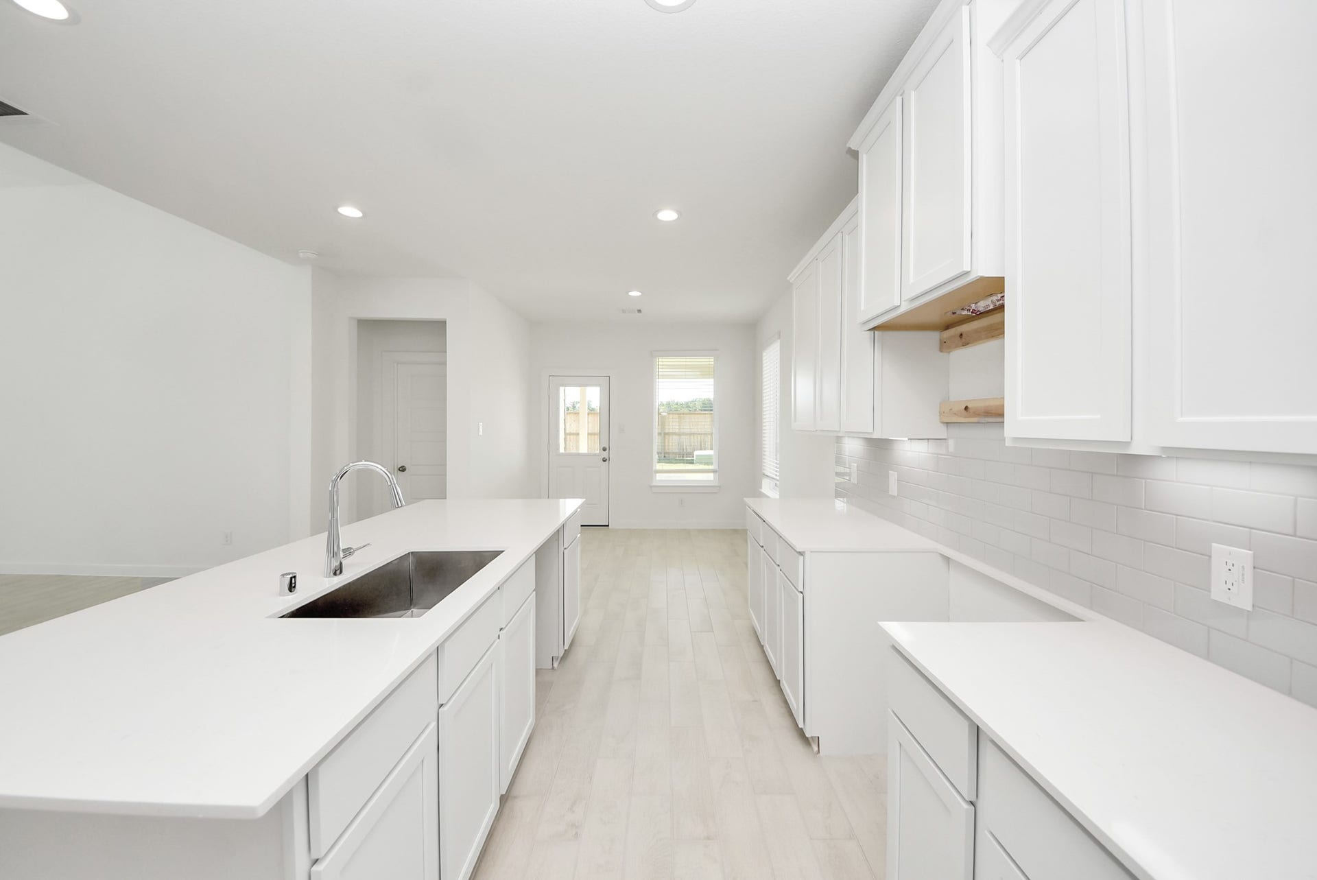 The open concept effortlessly connects the kitchen to the expansive family room, forming a perfect hub for gatherings. This seamless flow creates an inviting space where cooking and socializing come together harmoniously.
