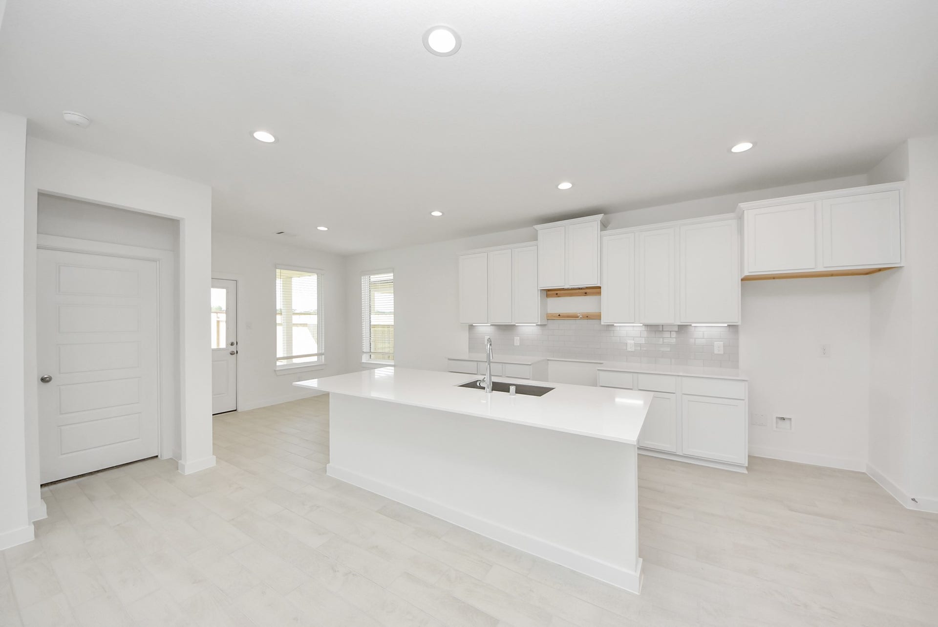 This kitchen is by far any chefs dream! This spacious kitchen features high ceilings, stained wood cabinets, granite countertop, SS appliances, modern tile backsplash, recessed lighting, extended counter space, granite kitchen island with double sink, and space for breakfast bar, and a walk-in pantry all overlooking your huge family room.