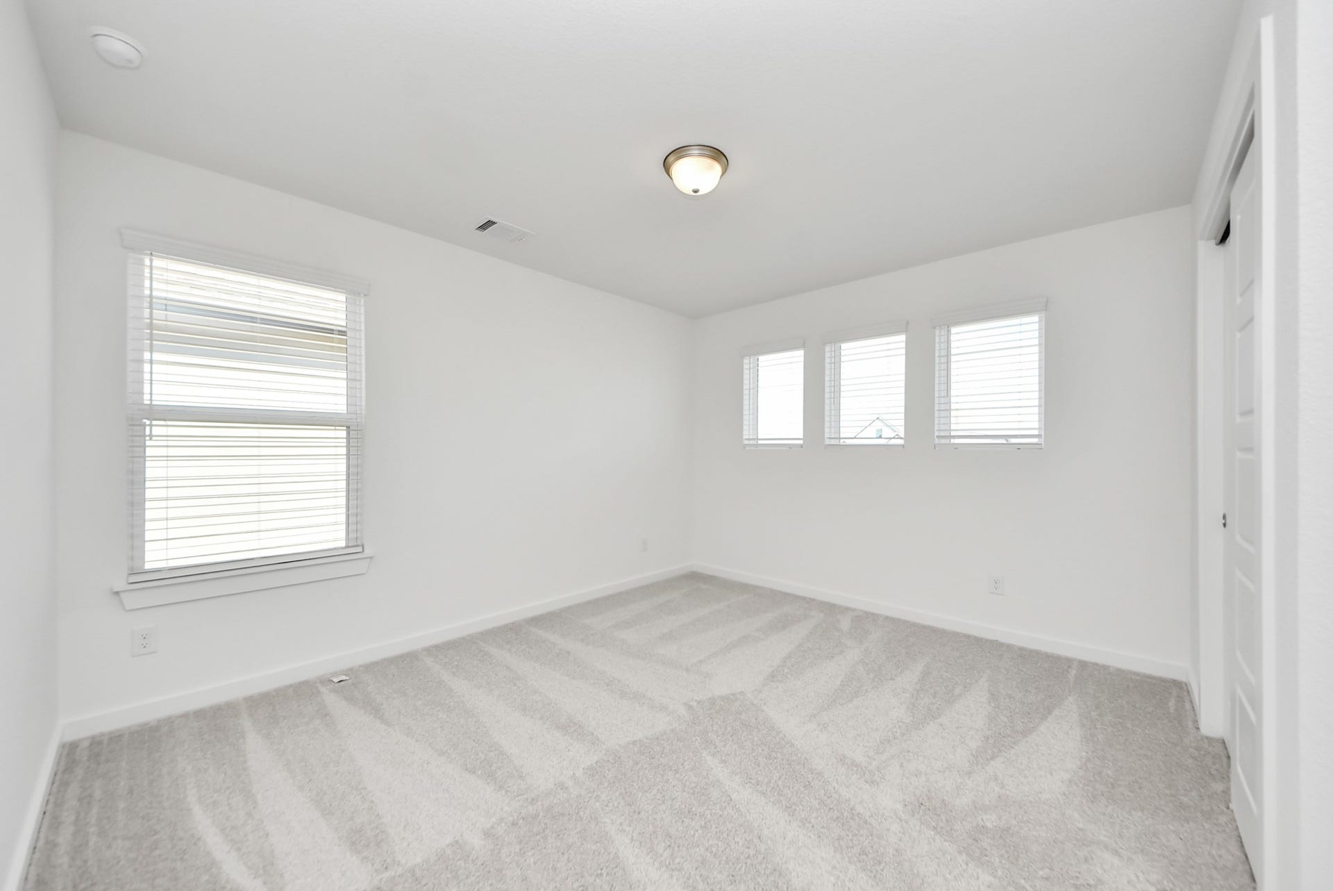 Discover a haven of leisure in this fantastic game room! Whether you're seeking a casual hangout or an adult gaming retreat, this space has it all. Enjoy the luxurious feel of plush carpet underfoot, the expansive ambiance of high ceilings, custom paint that adds a touch of personality, and windows that flood the room with refreshing natural light.