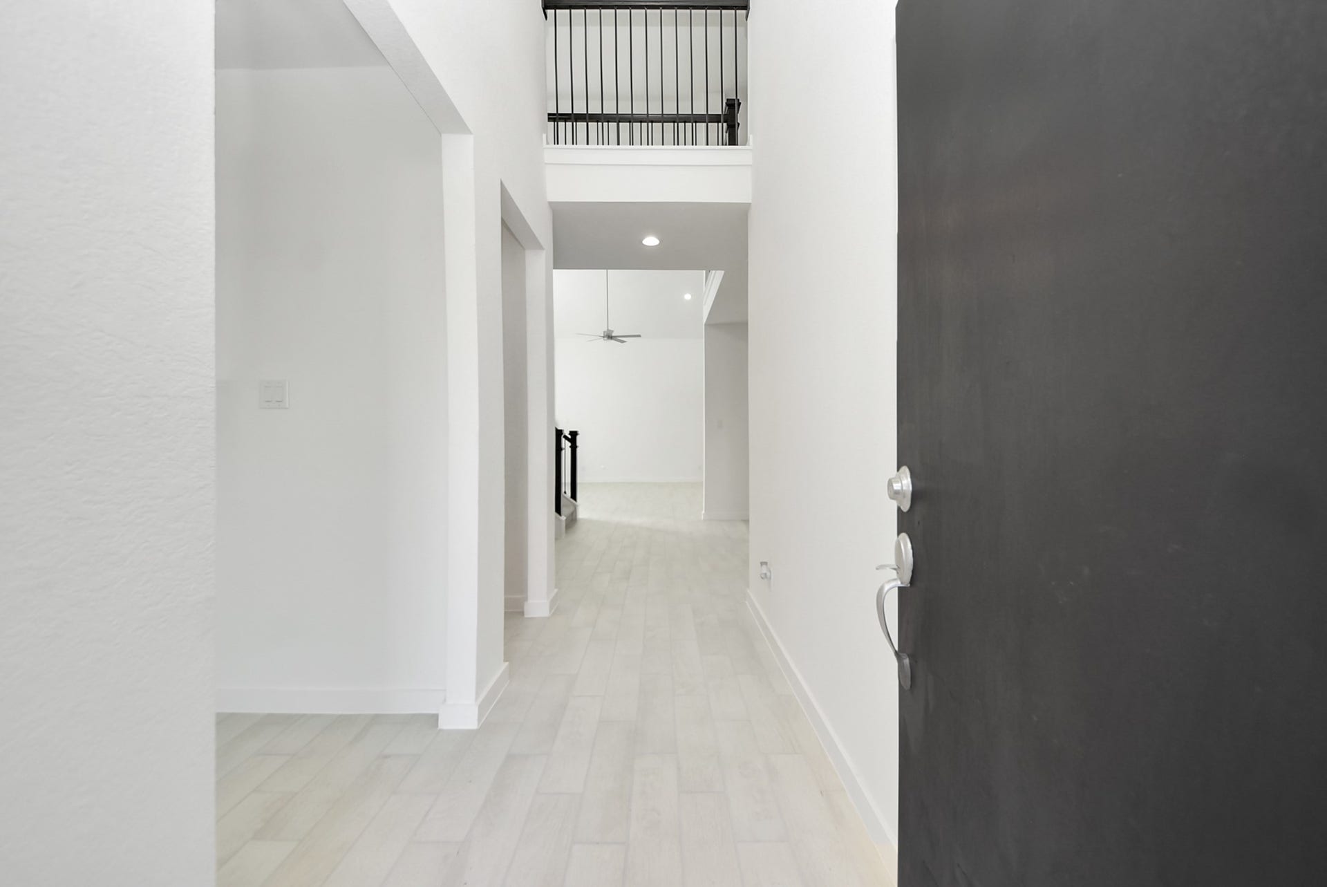 As you step into the threshold of this luxurious home, you'll soon be welcomed by an elegant glass door (to be installed). Inside, soaring ceilings amplify the spaciousness, while the refined wood-look tile flooring and oversized baseboards exude sophistication and charm.