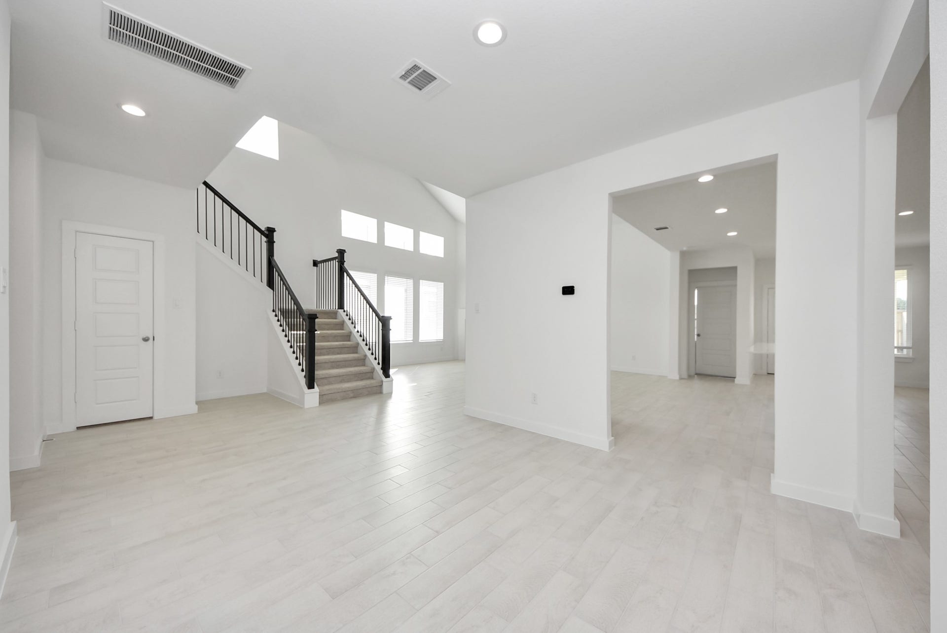 Create lasting memories with your family and friends at the dining table! This expansive dining room showcases sophisticated flooring, custom paint, and seamlessly connects to the family room and kitchen, providing an open and inviting atmosphere