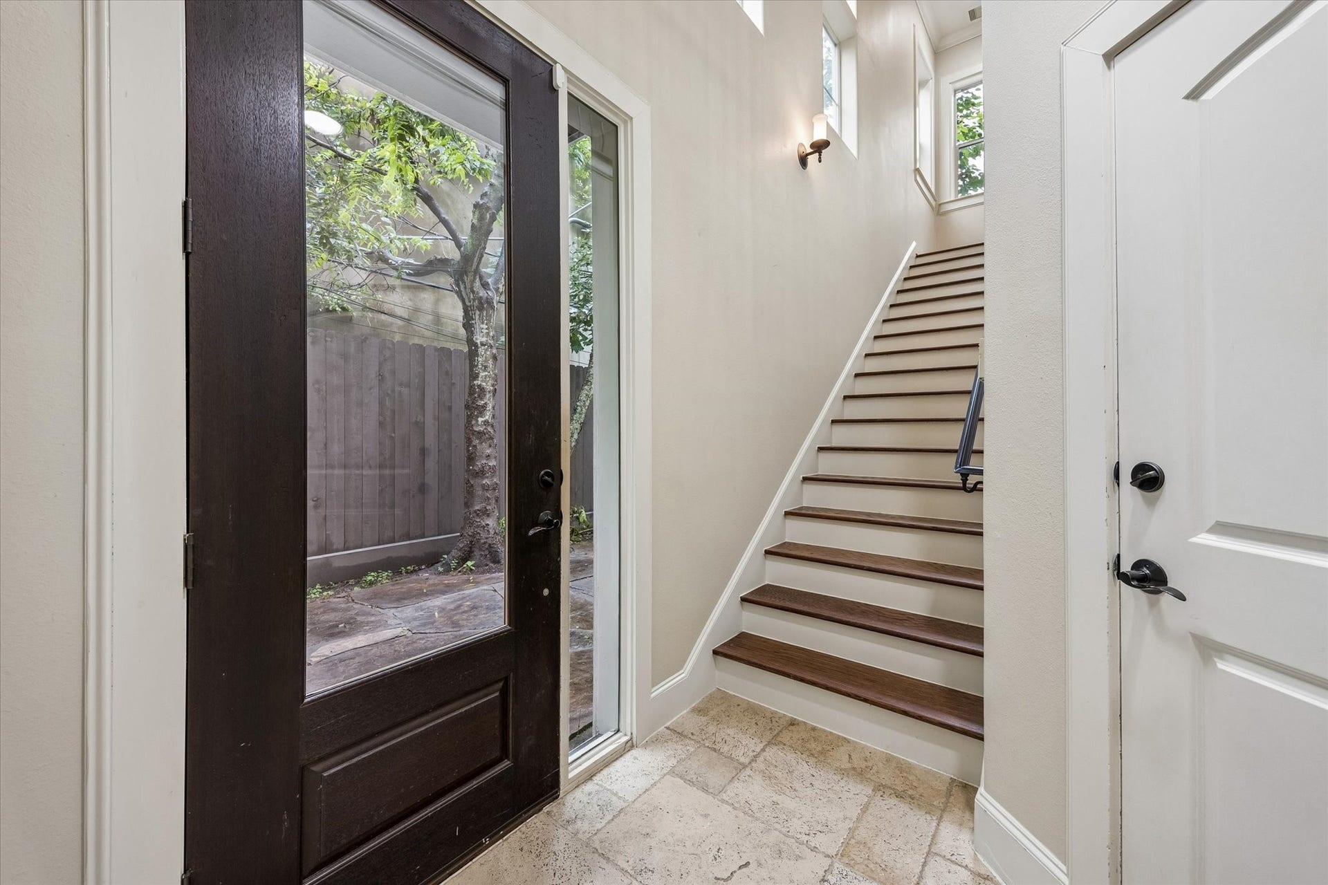 1112 Peveto Street, #C, Houston, TX 77019 The front door opens to stairs, garage access, and the first-floor bedroom.