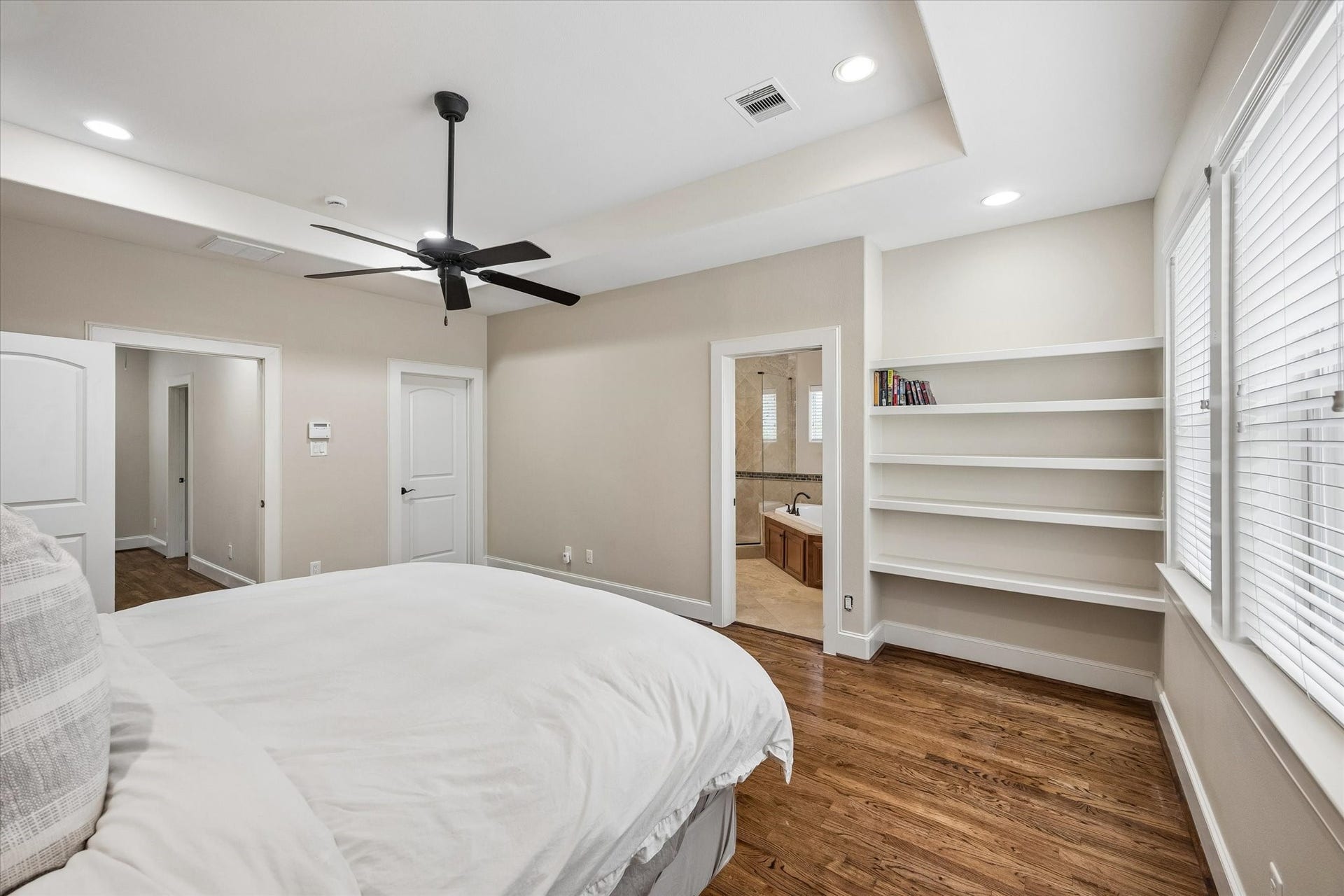 1112 Peveto Street, #C, Houston, TX 77019 Another view of the primary bedroom, looking toward the bathroom on the right and hallway on the left.