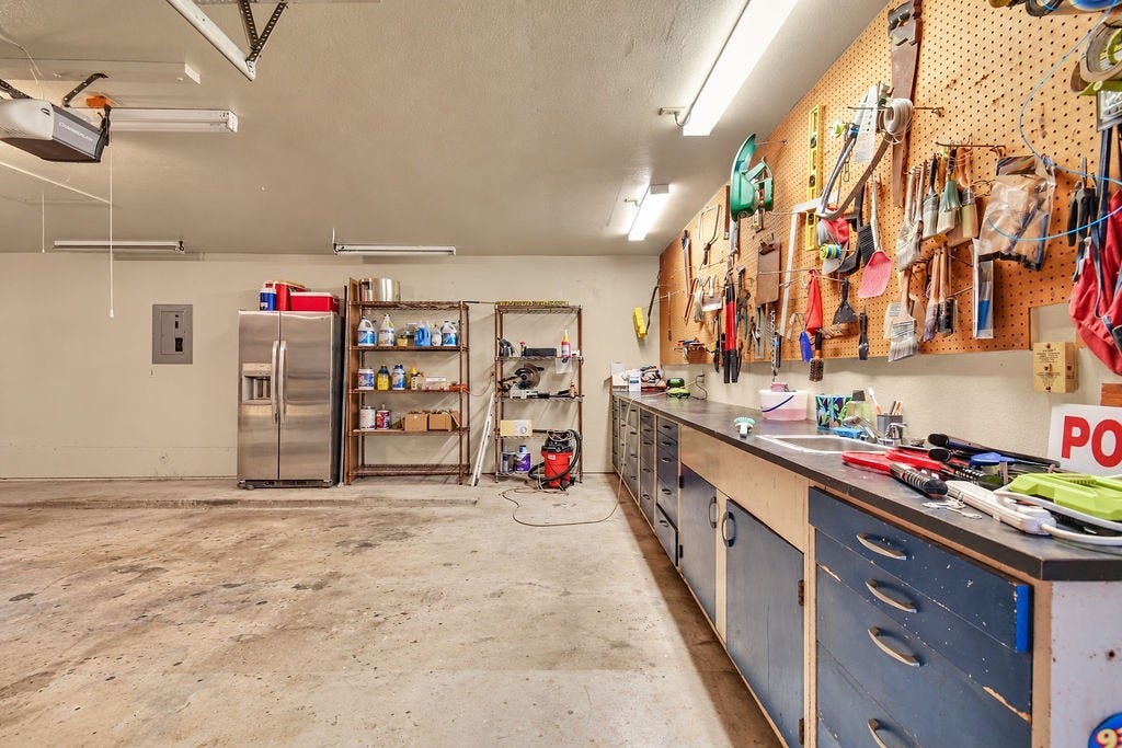 131 Frostwood Drive, Lake Jackson, TX 77566 Huge workbench in the 3 car garage with additional shelving