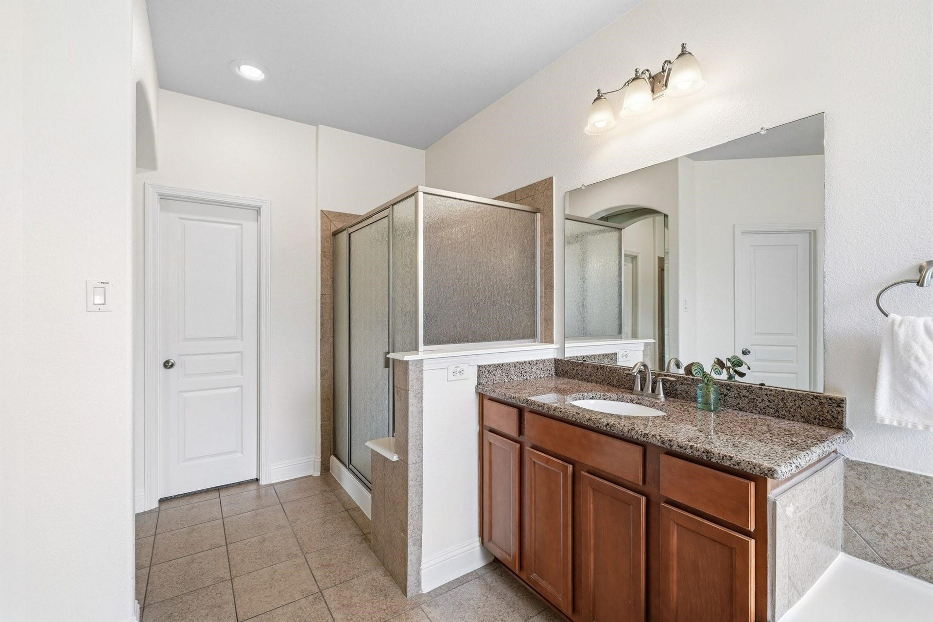 17610 Strackfield Lane, Tomball, TX 77377 The spacious walk-in shower features a built-in bench and elegant tile surround, creating a relaxing retreat, while the oversized closet with double hanging rods and dedicated shoe storage keeps everything impeccably organized.