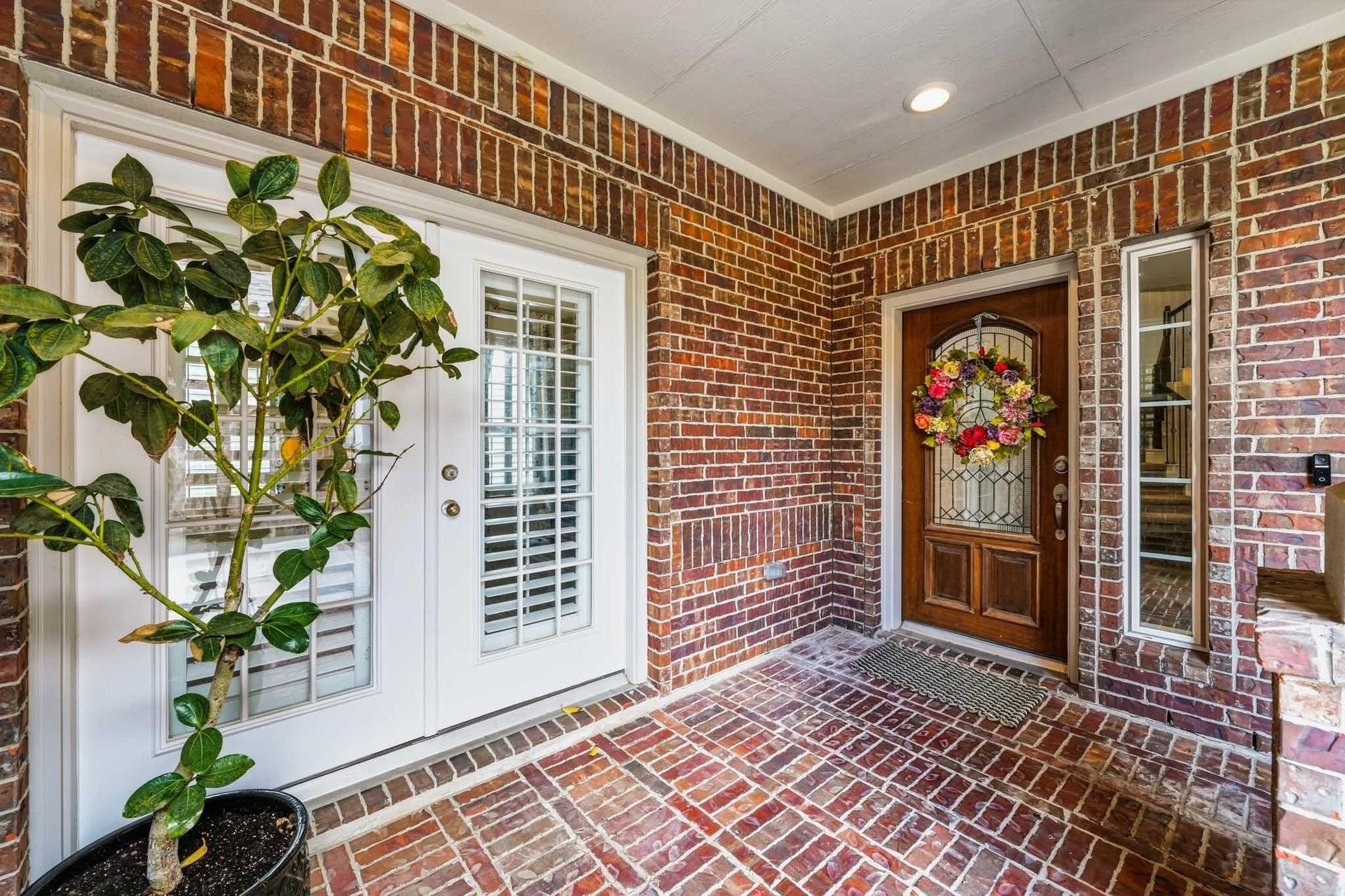 17610 Strackfield Lane, Tomball, TX 77377 A welcoming covered front porch creates an inviting first impression, with two entrances to the home. One is for the "Next Gen" suite for multigenerational living while the wood and glass entry door leads you to the main home.
