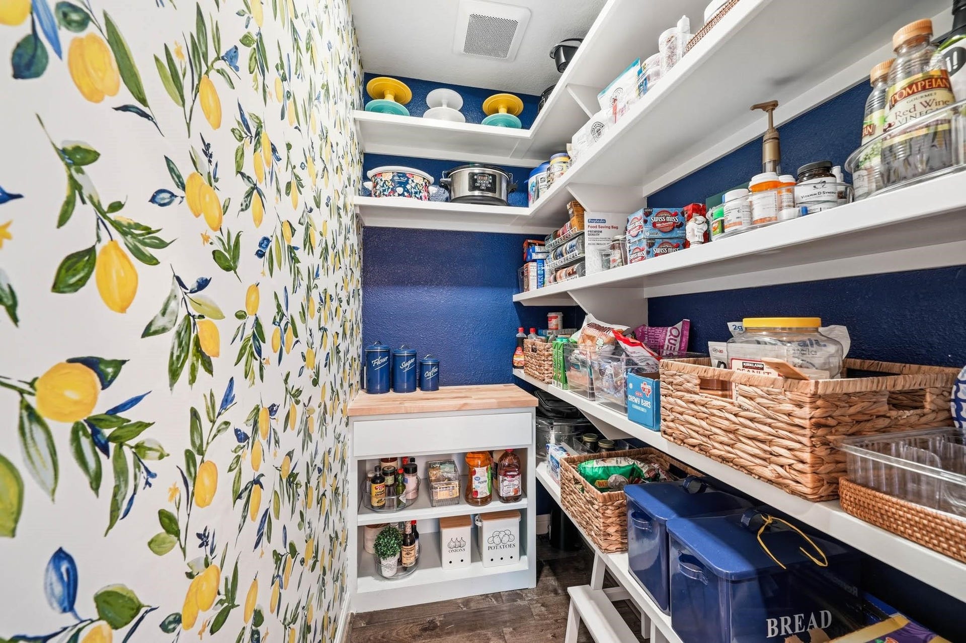 17610 Strackfield Lane, Tomball, TX 77377 The expansive pantry with bright and cheery wallpaper combines practicality with luxury, offering abundant storage that keeps everything organized and effortlessly accessible.