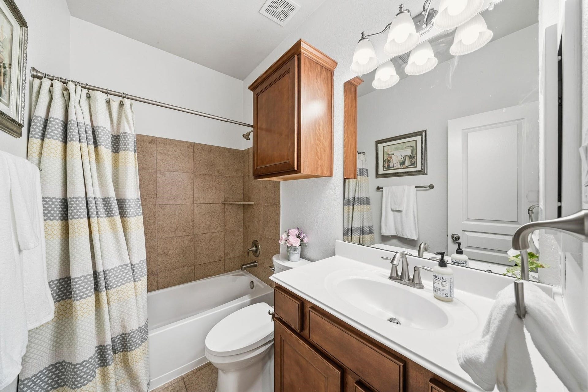 17610 Strackfield Lane, Tomball, TX 77377 A serene and self-contained retreat, the ensuite bath enhances everyday convenience, while tile floors, a cultured marble sink and a tiled tub-shower surround create a timeless, low-maintenance space.