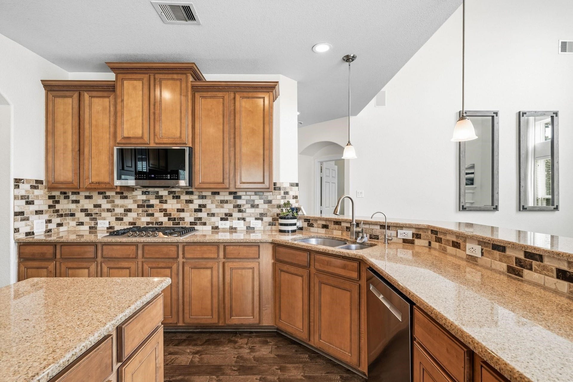 17610 Strackfield Lane, Tomball, TX 77377 A perfect blend of beauty and practicality, this kitchen features granite countertops with decorative tile back splash that elevates the entire space along with plenty of storage space.