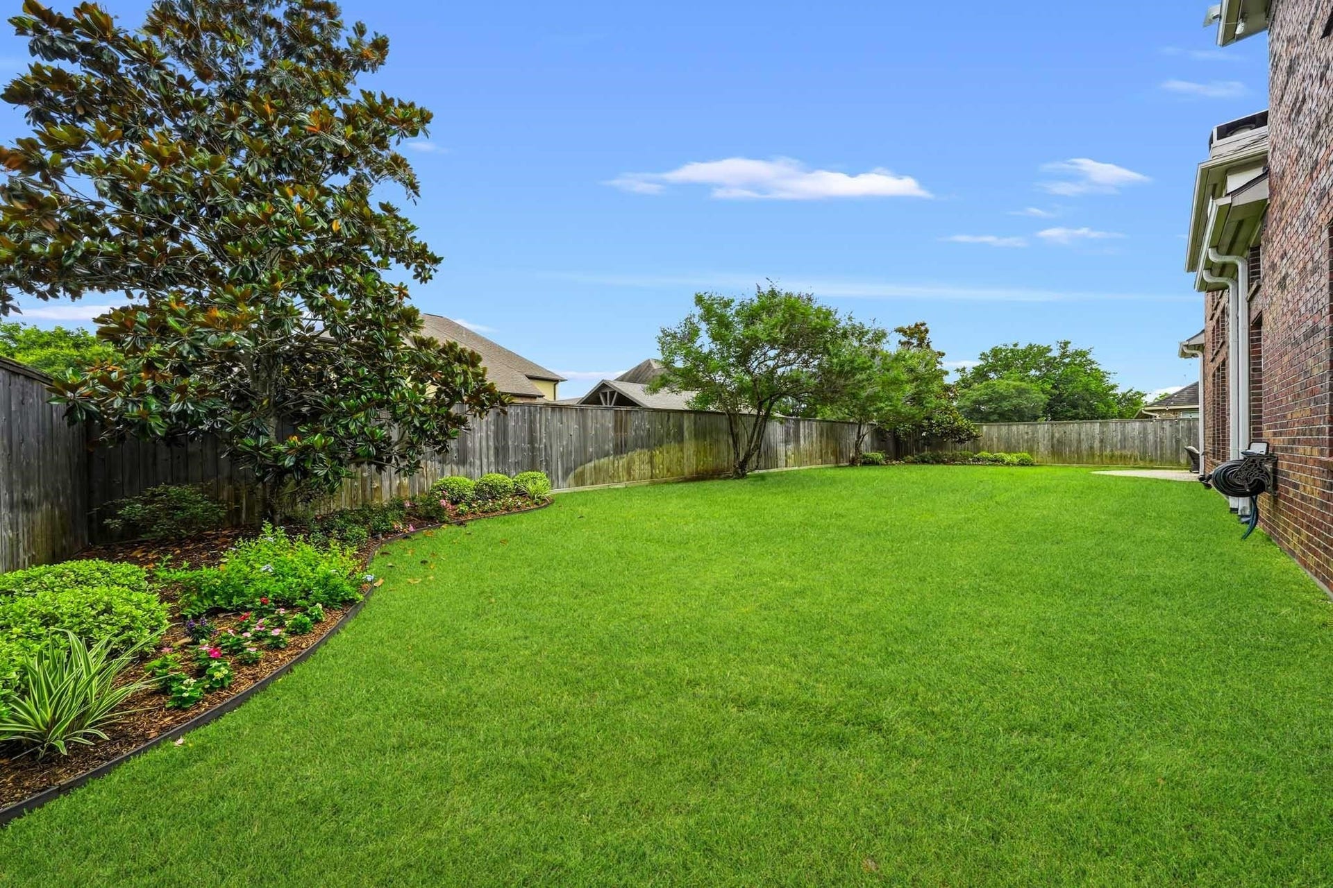 17610 Strackfield Lane, Tomball, TX 77377 A beautifully maintained backyard retreat awaits, complete with mature trees, sweeping lawn space, and plenty of room for pets to roam.