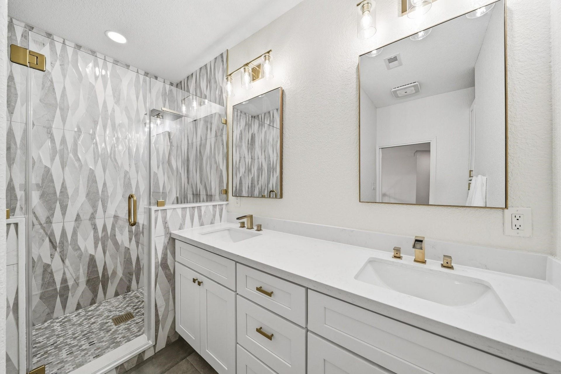 17610 Strackfield Lane, Tomball, TX 77377 The fourth bath is a true showpiece, remoldeled featuring oversized 12x24 tile floors, dual sink Quartz-topped vanities, designer gold fixtures and mirrors, and a spectacular frameless shower wrapped in floor-to-ceiling tile with both a rain head and separate spray wand.
