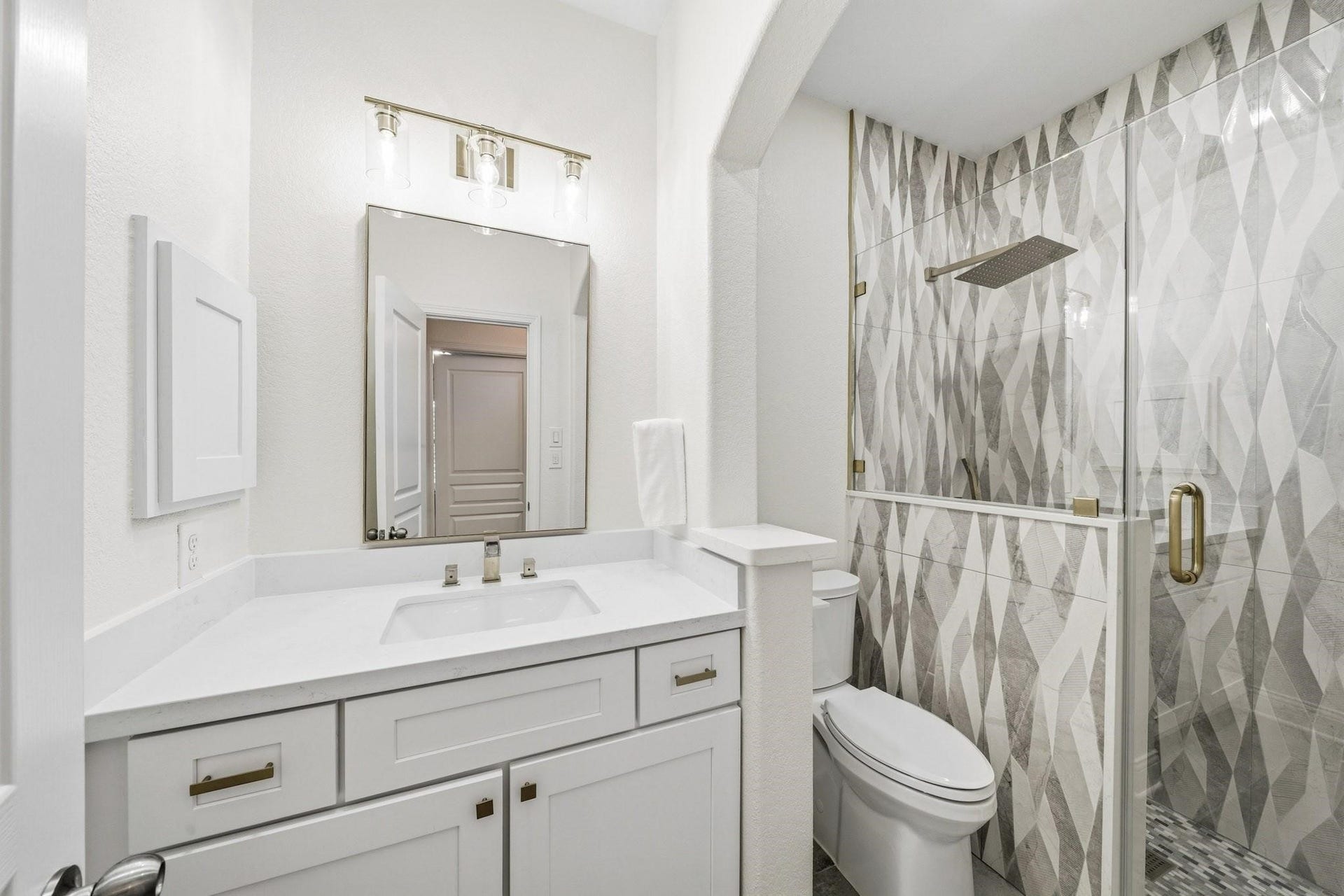 17610 Strackfield Lane, Tomball, TX 77377 The third bath has been beautifully reimagined with oversized 12x24 tile floors, Quartz counters, and a stunning floor-to-ceiling tiled shower featuring a rain head and separate spray wand for a spa-inspired experience.