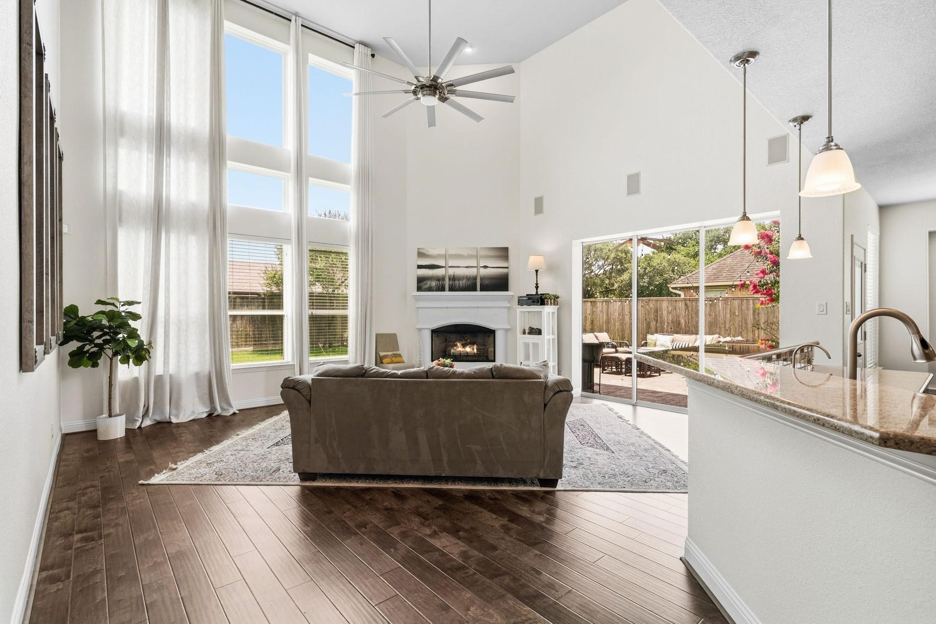 17610 Strackfield Lane, Tomball, TX 77377 Soaring two-story ceilings, rich hardwood floors and a dramatic wall of windows dressed with blinds and drapes create a stunning gathering space filled with natural light.