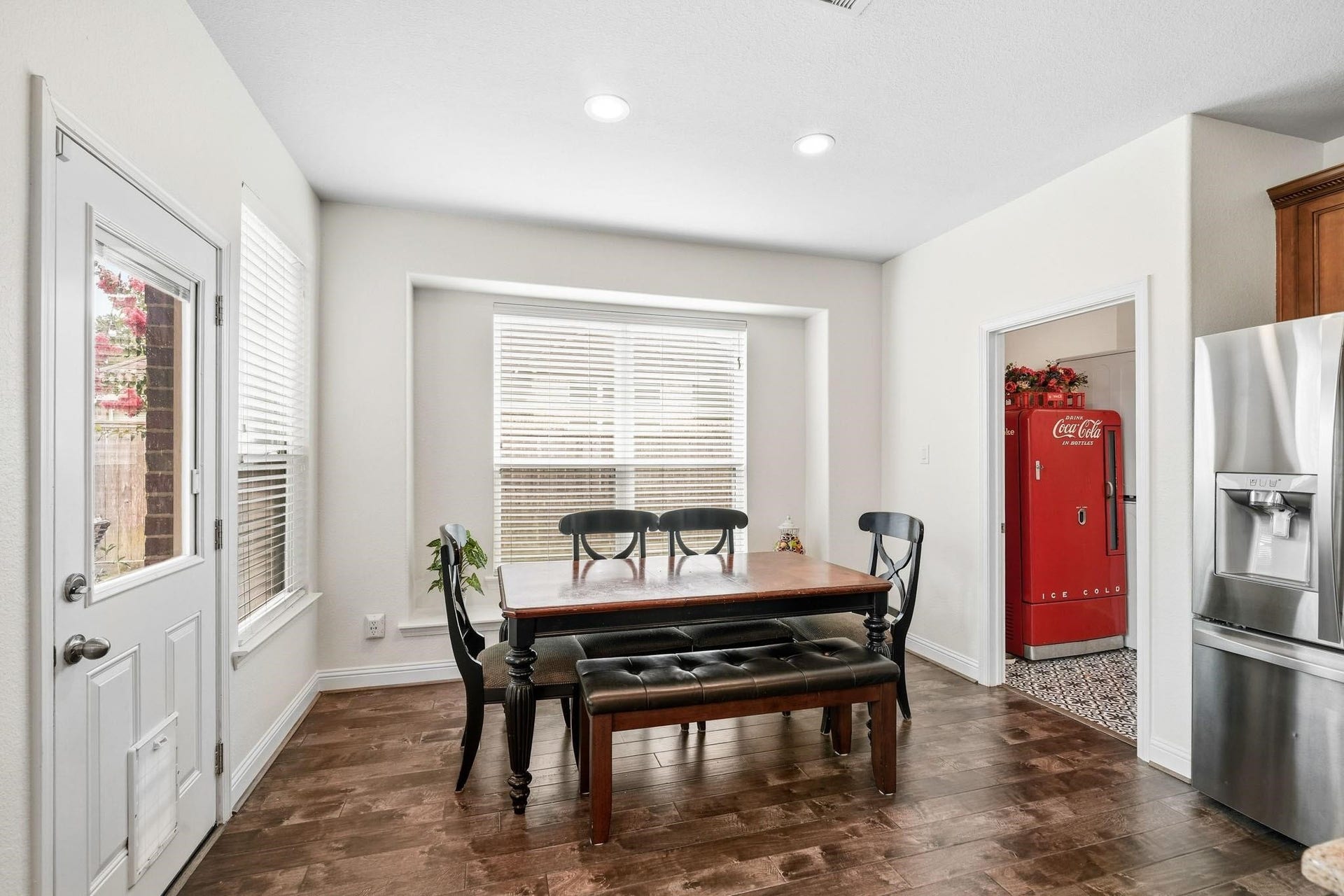 17610 Strackfield Lane, Tomball, TX 77377 Bathed in natural light, this cheerful breakfast nook features a cozy window seat and seamless access to the patio through a glass door, blending indoor comfort with outdoor enjoyment. The laundry room sits to the right.