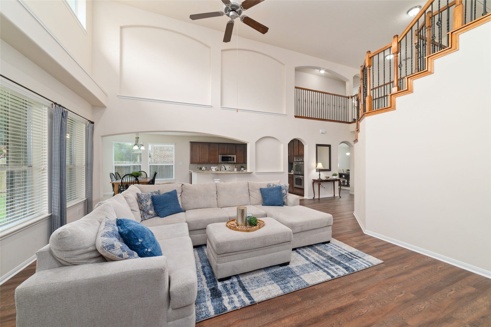 14422 Lakepointe Bend Lane, Cypress, TX 77429 Vaulted ceilings, arched walkways and art niches add elegant architectural detail to the bright open living room at the heart of the home.