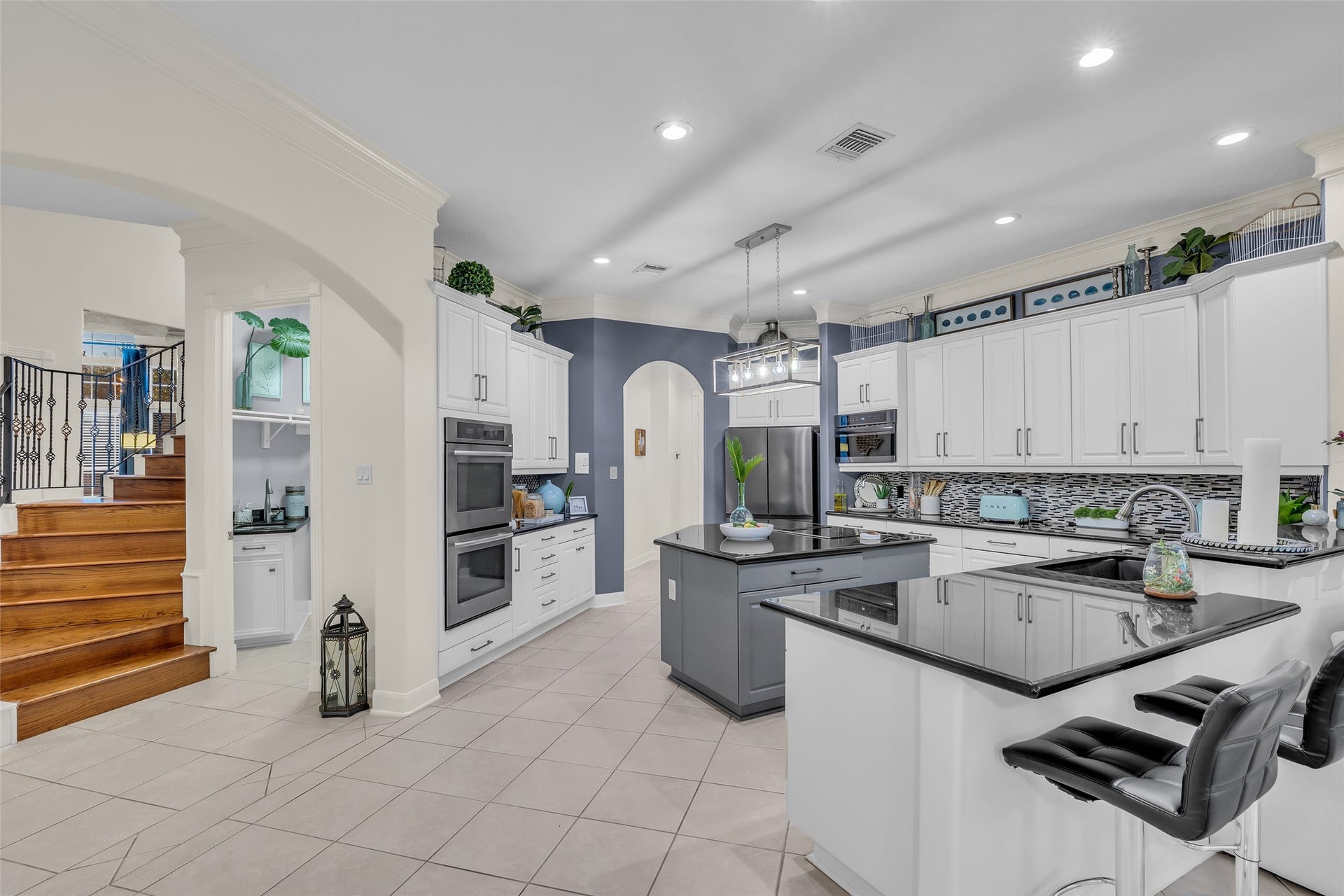 19023 Windsor Lakes Drive, Houston, TX 77094 The kitchen has been updated with a contemporary backsplash, painted cabinets and appliances.