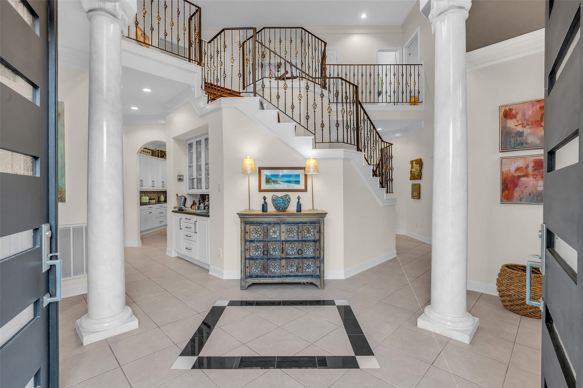 19023 Windsor Lakes Drive, Houston, TX 77094 Elegant entry with grand staircase and wrought-iron railing.