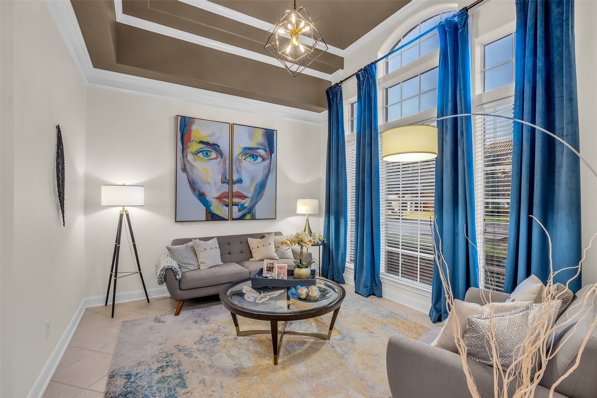 19023 Windsor Lakes Drive, Houston, TX 77094 A stylish formal living room features high ceilings, large windows and a contemporary light fixture.