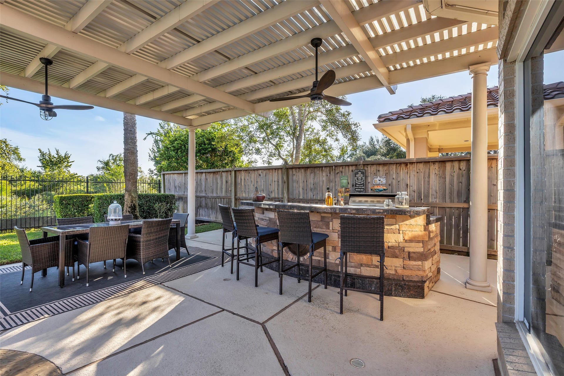 19023 Windsor Lakes Drive, Houston, TX 77094 There is a built-in BBQ and fridge in the bar area. Perfect backyard for entertaining.