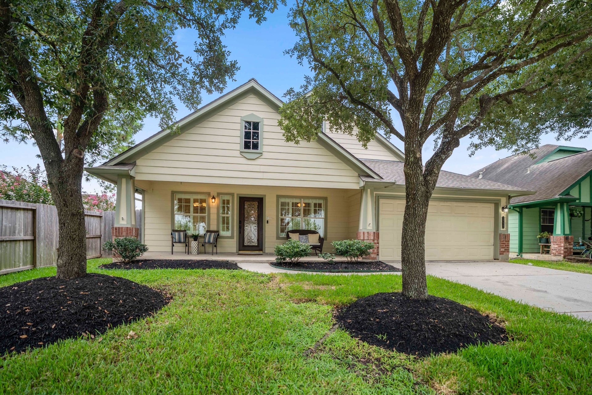 19422 Camellia Bend Circle, Spring, TX 77379 Welcome home to Stone Forest, where a covered front porch stretches across the front of the home beneath the shade of mature trees. The walkway leads directly to the front entry, with the attached 2-car garage positioned to the right and plenty of porch space to settle in before stepping inside.