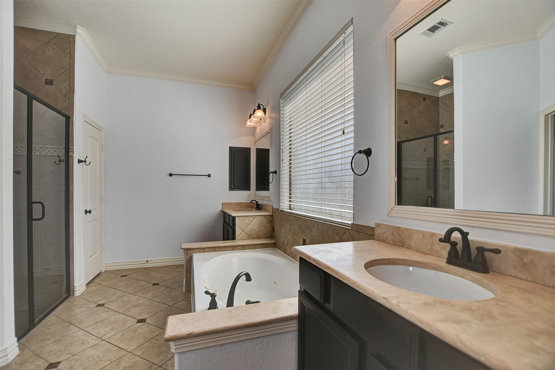 Separate large shower with glass door.