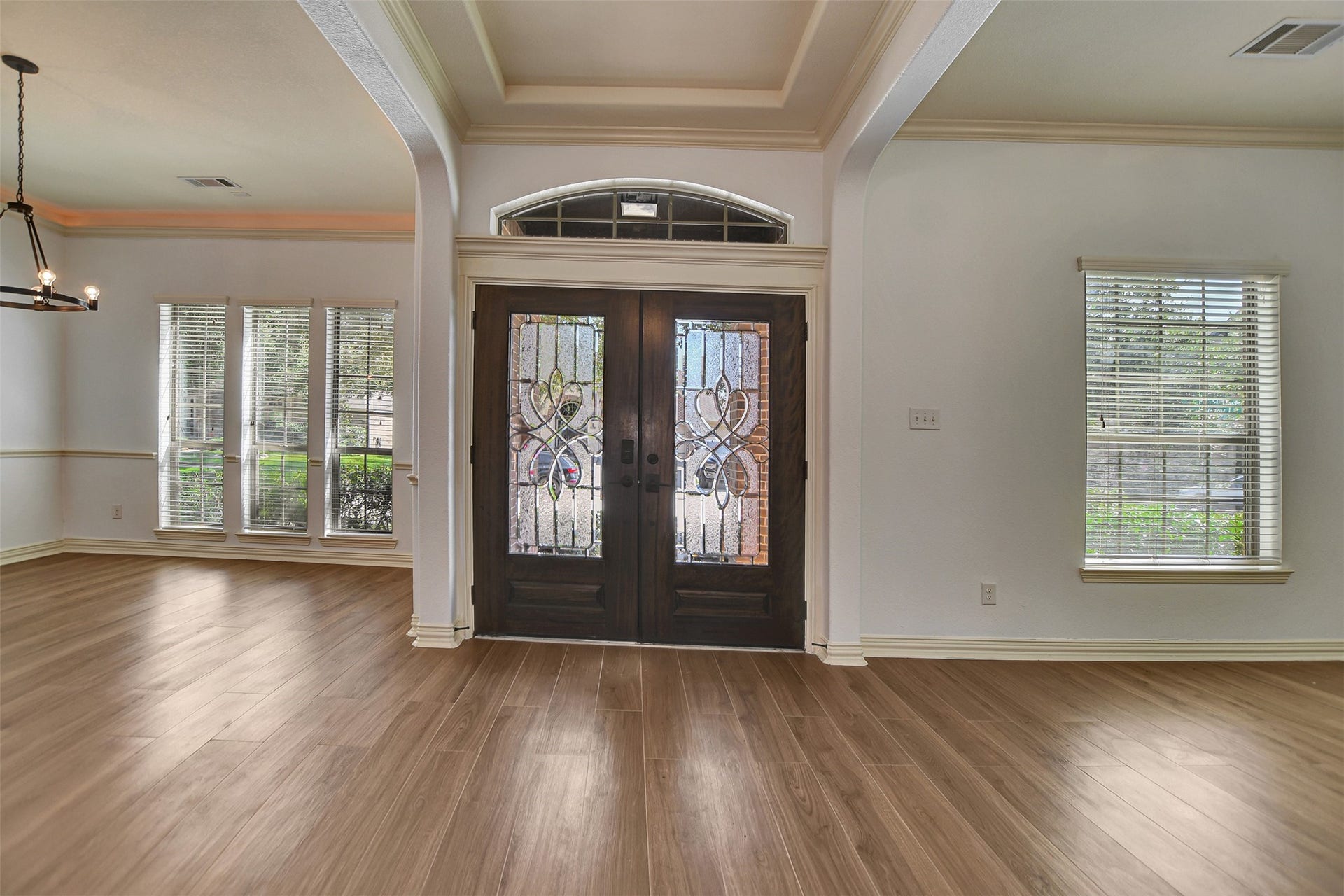 Beautiful double wood doors welcome you to this home.