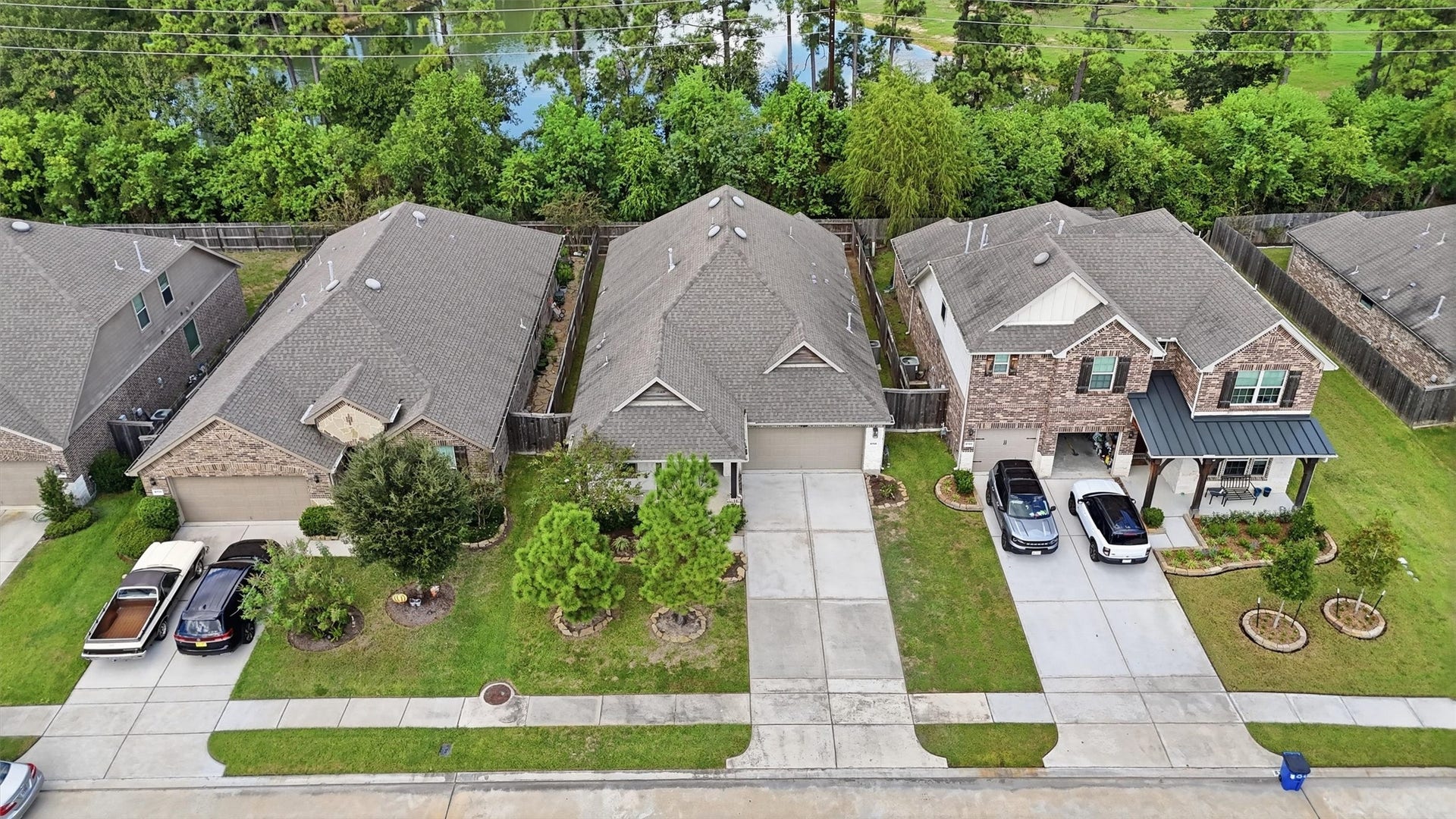 9726 Birdsnest Court, Spring, TX 77379 Beautiful single-story home featuring a stone-and-brick exterior, welcoming covered entry, manicured landscaping, and a two-car garage.