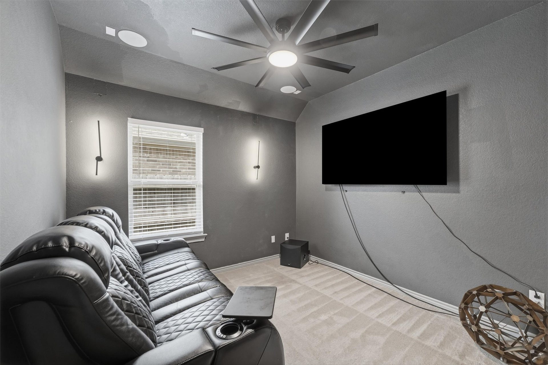 9726 Birdsnest Court, Spring, TX 77379 Dedicated media room featuring a large wall-mounted TV, comfortable theater seating, modern lighting, and ceiling fan.