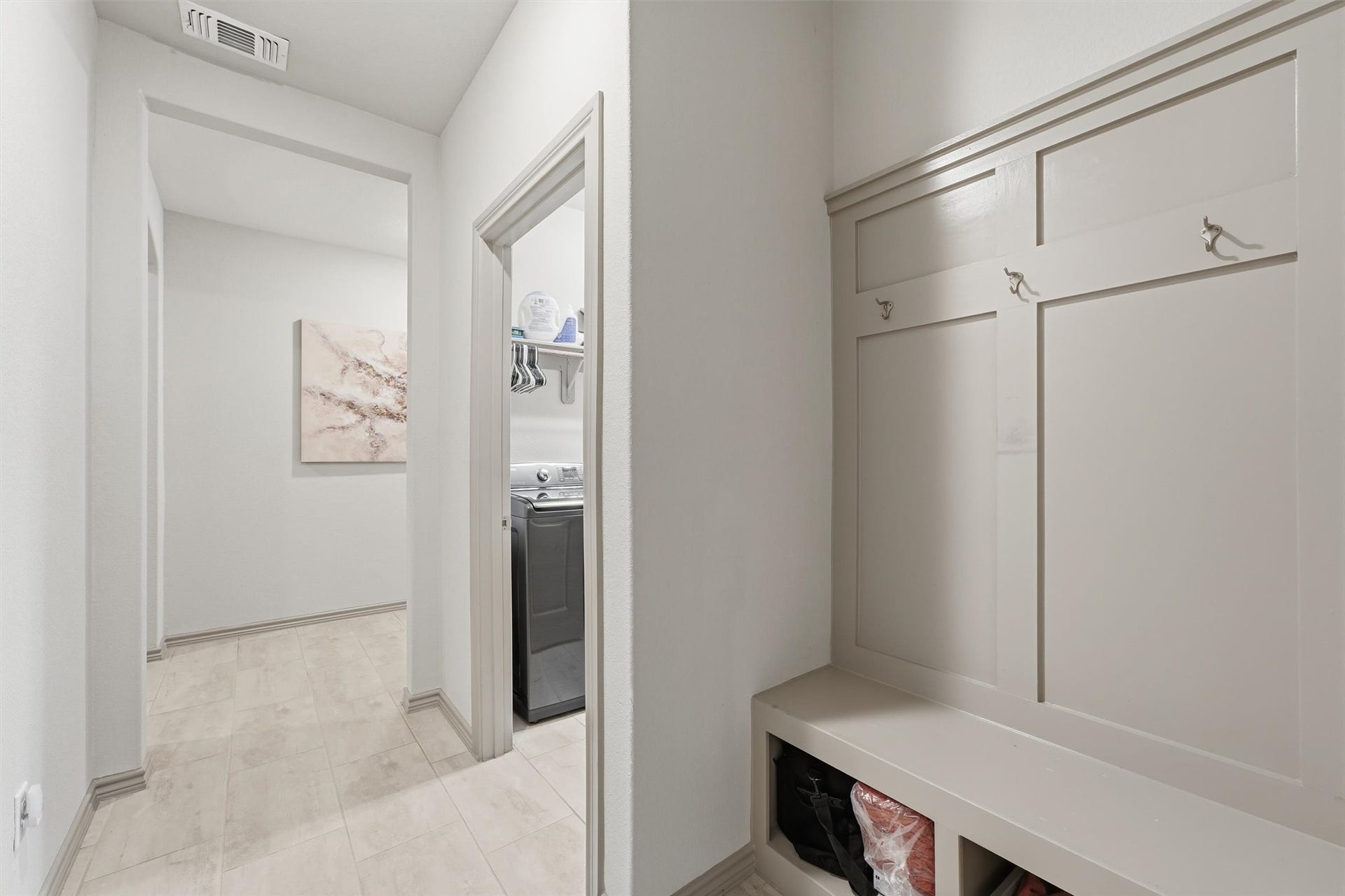 9726 Birdsnest Court, Spring, TX 77379 Convenient mudroom featuring custom built-in bench seating, coat hooks, and easy access to the laundry room.