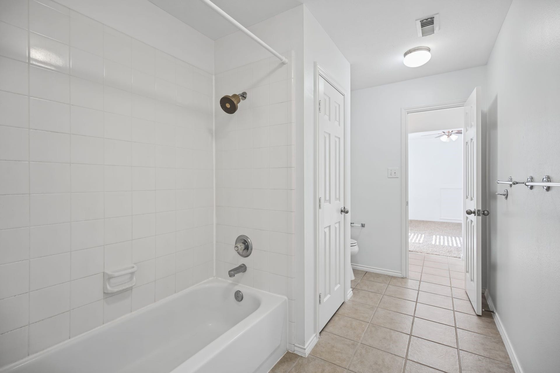 This reverse angle shows the tiled flooring and the connection back toward the bedroom.