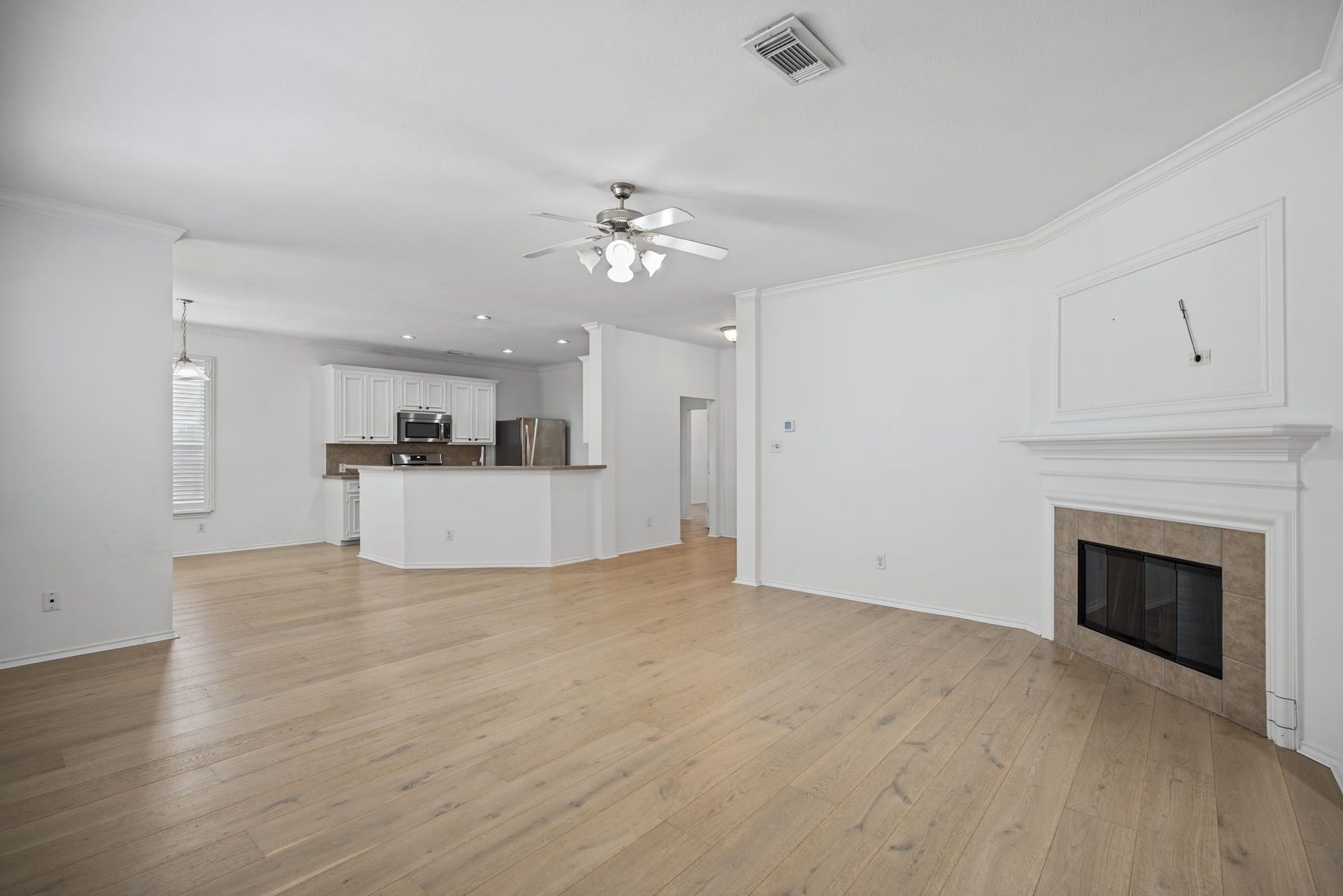 Looking toward the kitchen, the fireplace surround adds a focal point to the open living space.