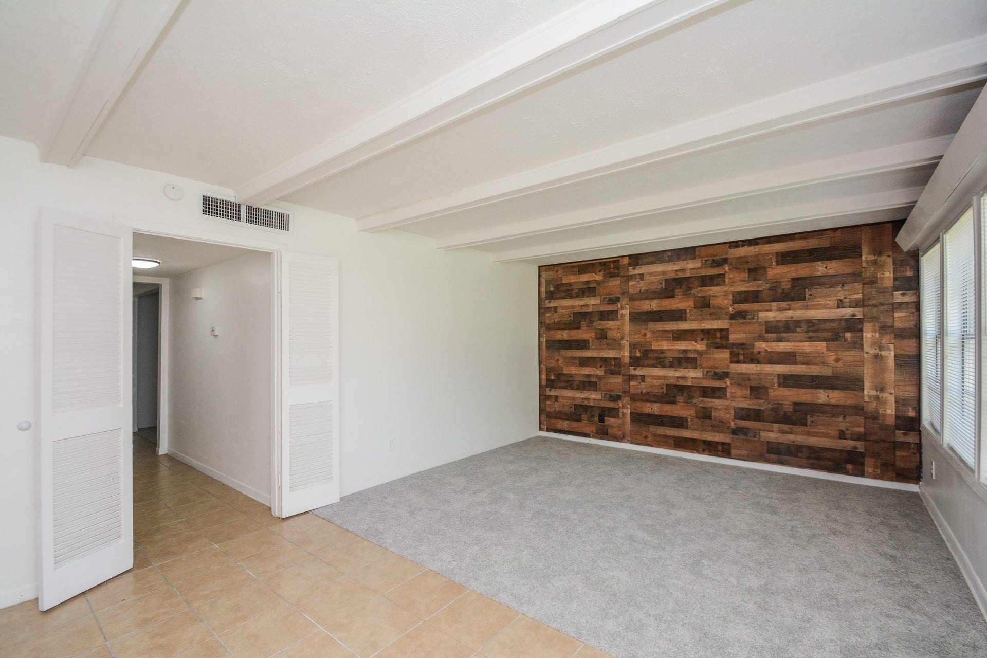 Accented feature wall off of the living area which opens to kitchen