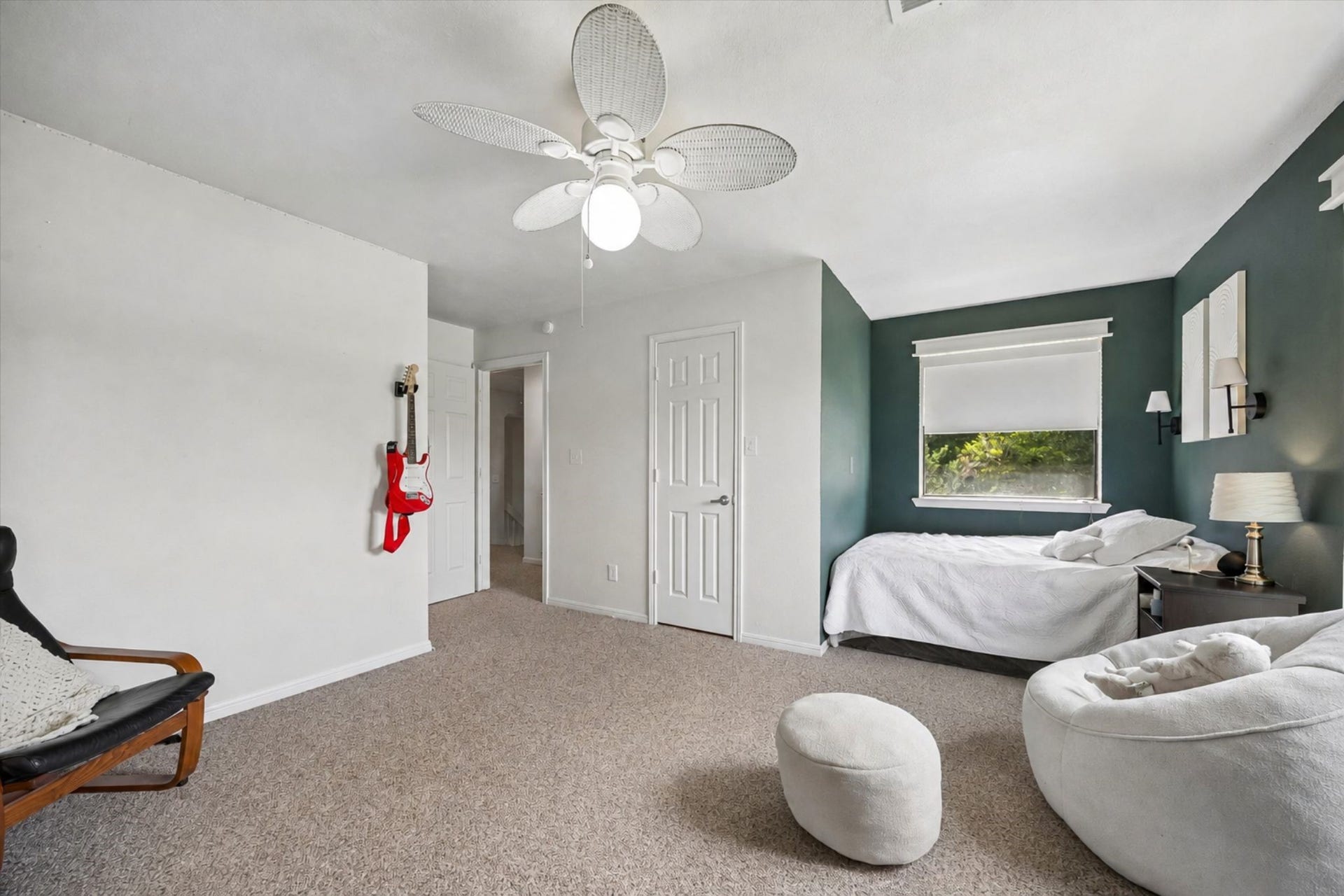 2020 PECAN LAKE DRIVE, Richmond, TX 77406 SPACIOUS BEDROOM FEATURES A DISTINCTIVE ACCENT WALL, LARGE WINDOW, CEILING FAN, AND GENEROUS FLOOR SPACE.