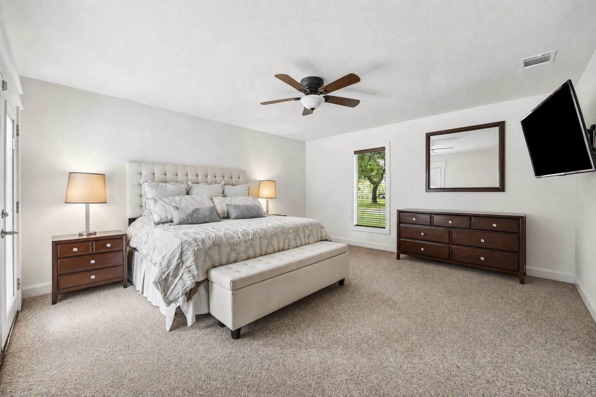 2020 PECAN LAKE DRIVE, Richmond, TX 77406 PRIVATE TENNIS COURT SURROUNDED BY EXPANSIVE LAWN AND MATURE TREES, CREATING A SPACIOUS OUTDOOR RECREATION AREA.