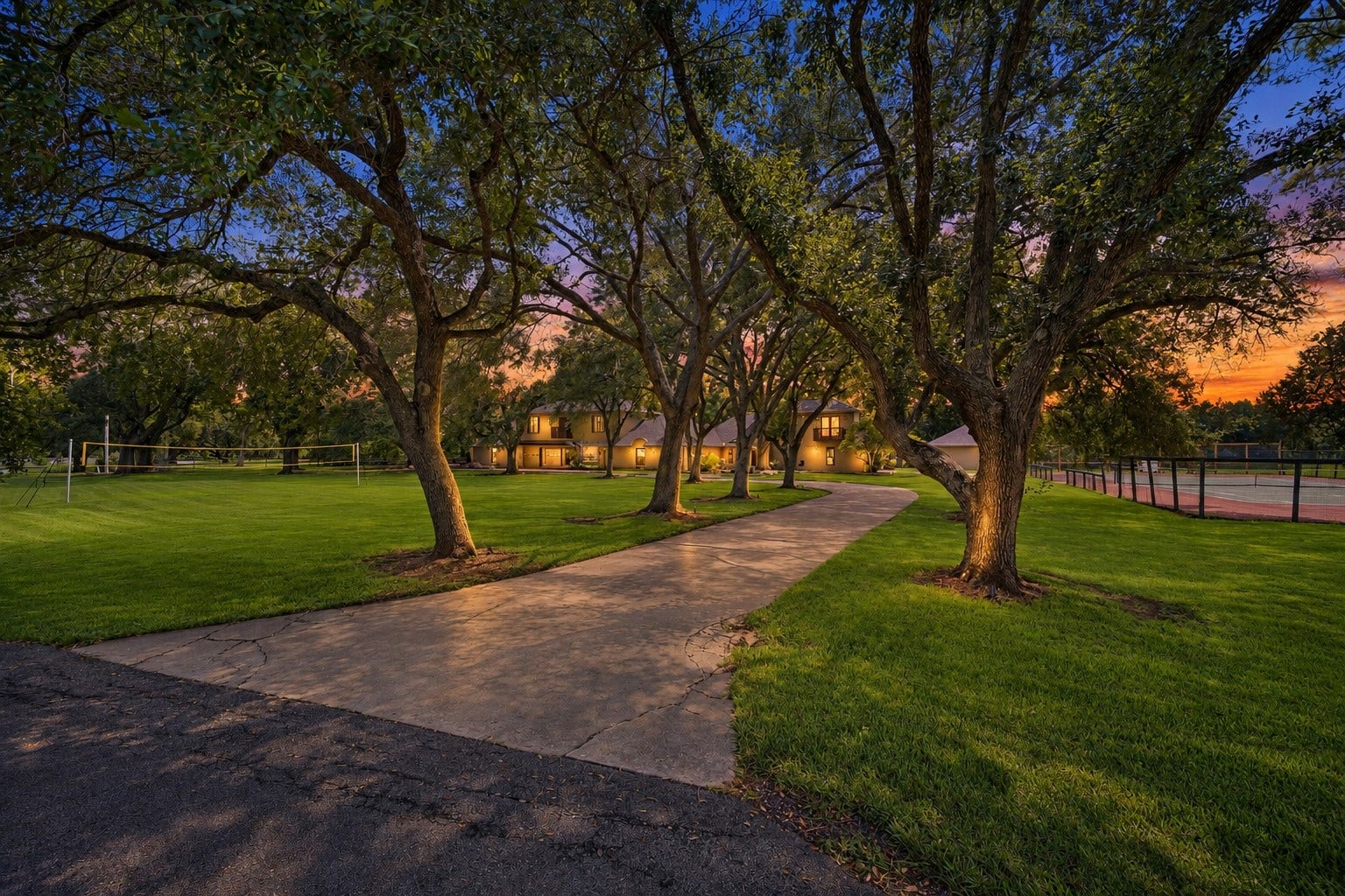 2020 PECAN LAKE DRIVE, Richmond, TX 77406 LONG, TREE-LINED DRIVEWAY WINDS THROUGH THE PROPERTY, PROVIDING A SHADED APPROACH SURROUNDED BY MATURE LANDSCAPING.