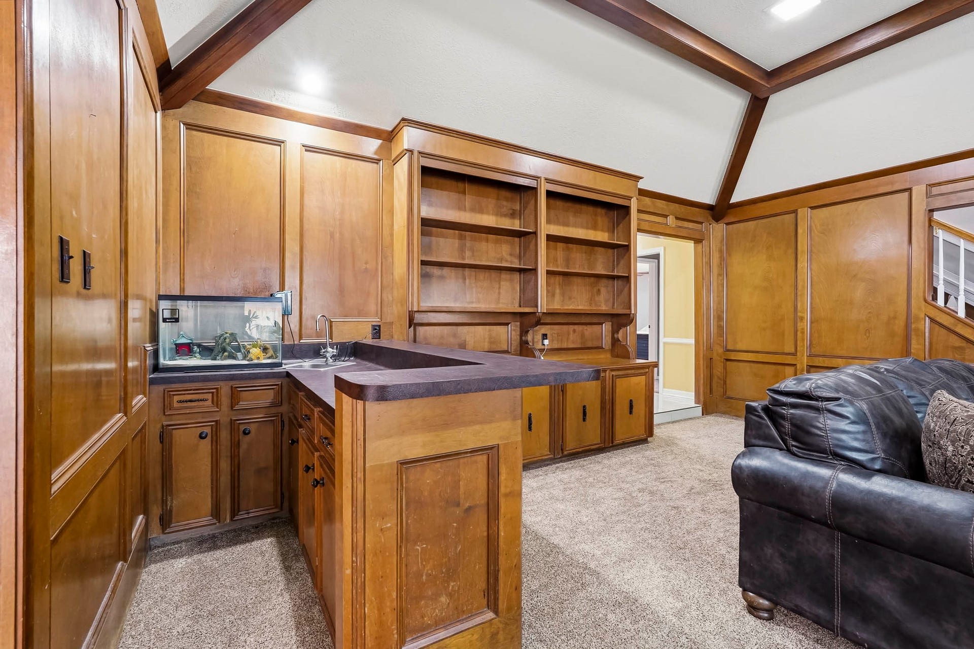 3610 Valley Haven Drive, Houston, TX 77339 Charming den with rich wood paneling, built-in shelving, and a wet bar, ideal for entertaining or relaxing.