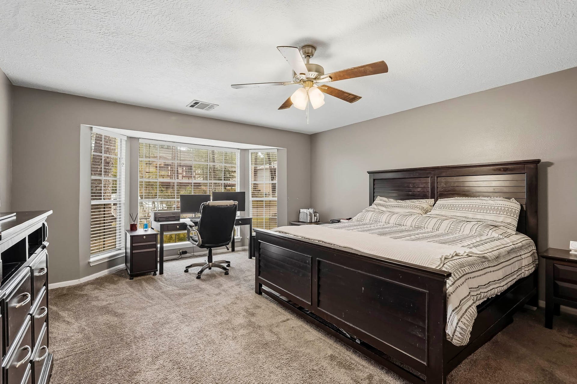 3610 Valley Haven Drive, Houston, TX 77339 Spacious primary bedroom with soft carpeting and a large bay window offering abundant natural light.