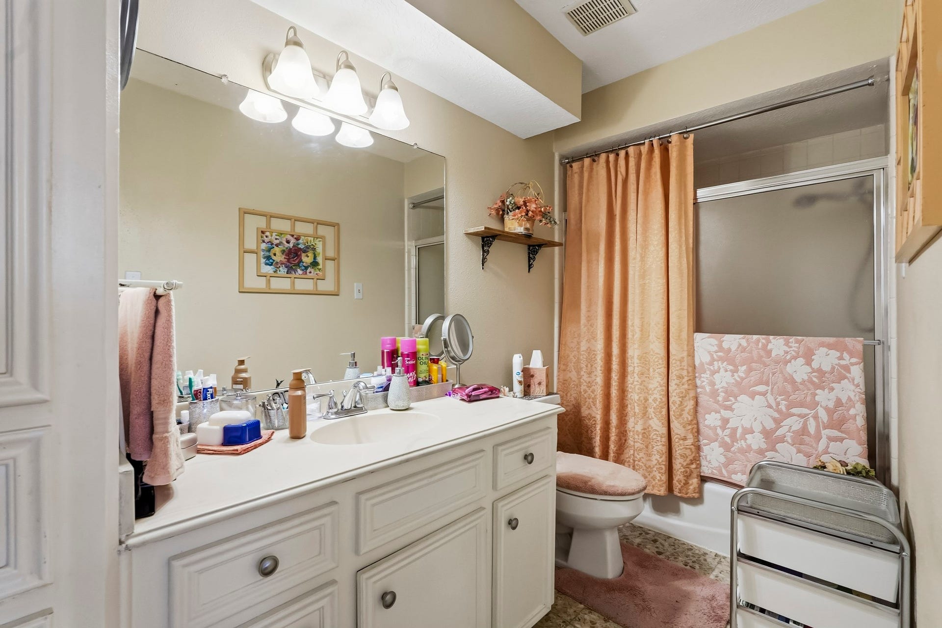 3610 Valley Haven Drive, Houston, TX 77339 Charming secondary bathroom featuring a spacious vanity with ample storage, elegant lighting, and a tub-shower combination.