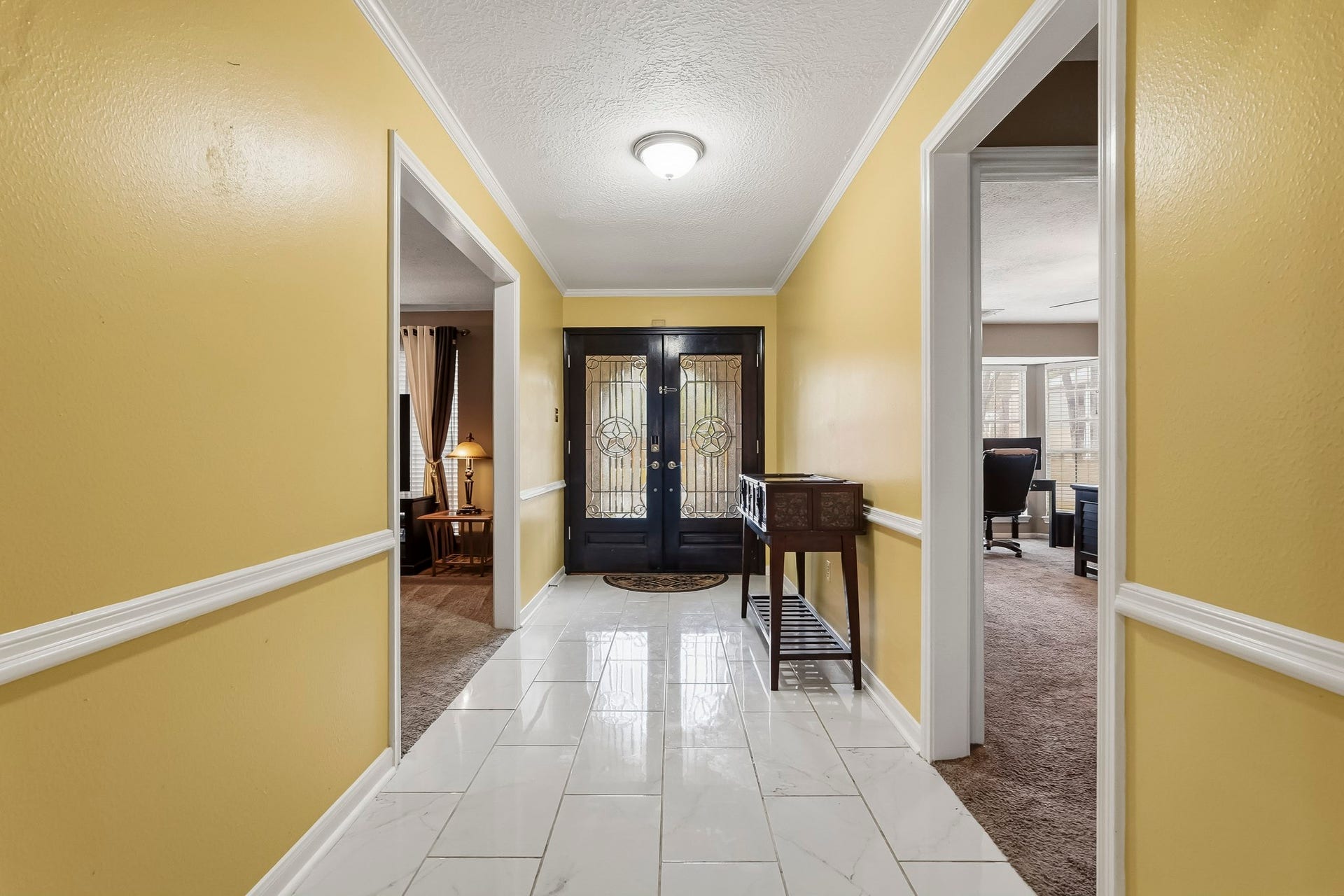 3610 Valley Haven Drive, Houston, TX 77339 Bright and welcoming entryway featuring elegant tile flooring and a stylish black front door with decorative glass panels.