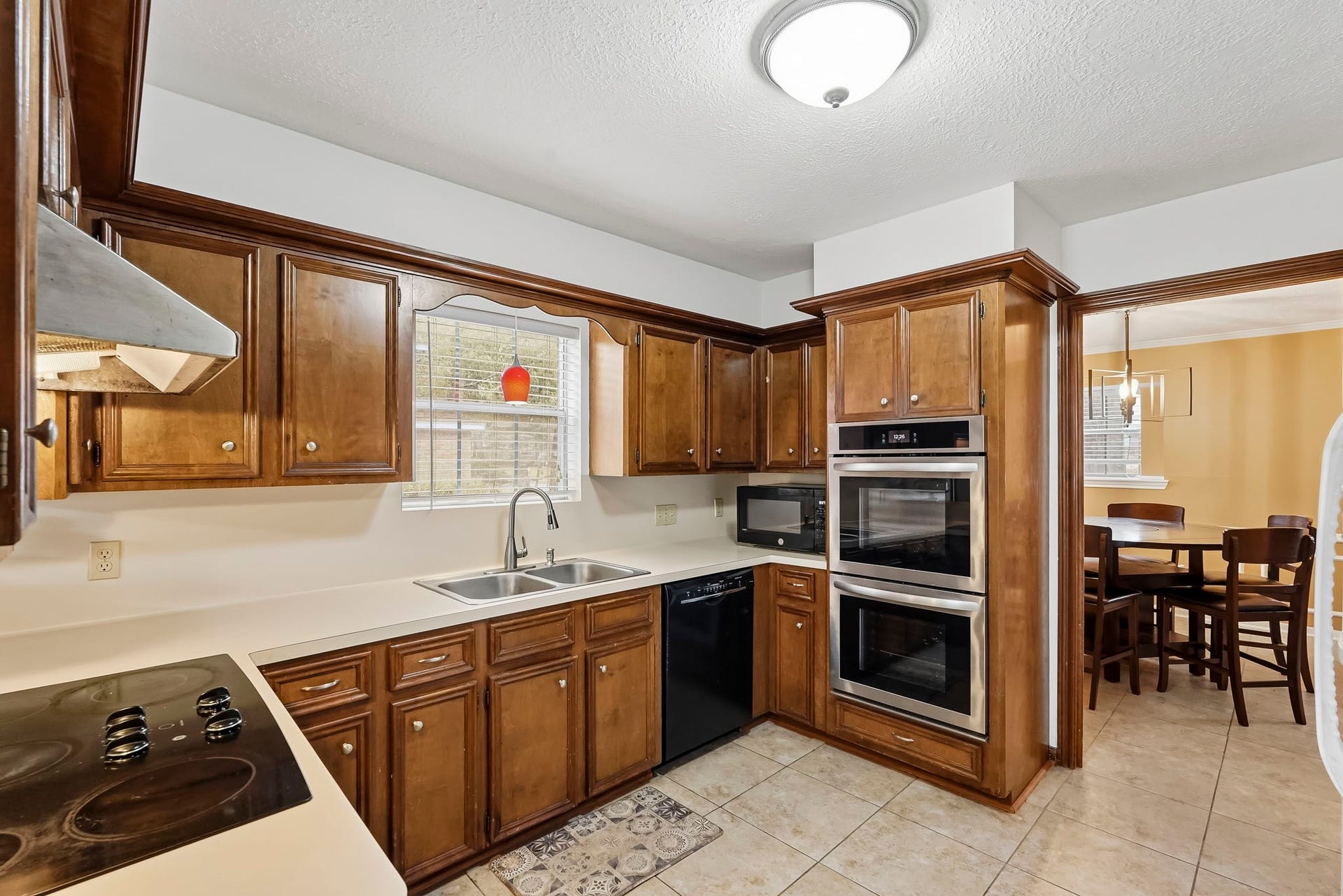 3610 Valley Haven Drive, Houston, TX 77339 Charming kitchen with rich wooden cabinetry, modern double ovens.